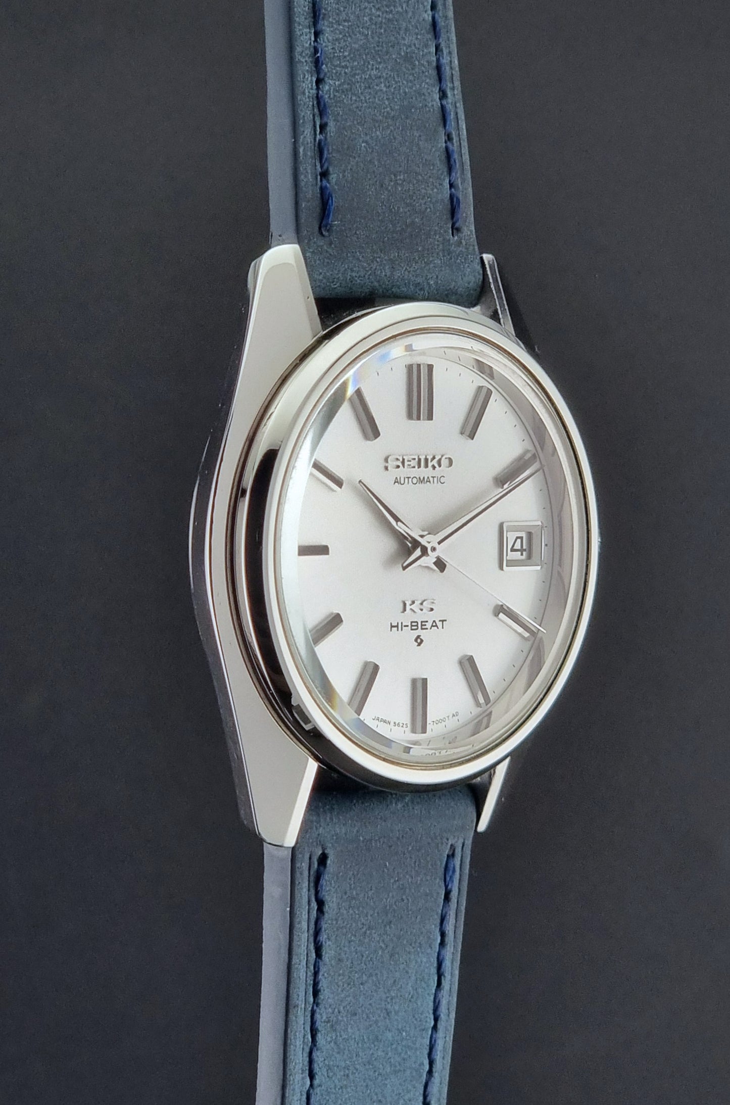 Vintage King Seiko 5625-7000 Wristwatch with blue strap and silver case on a dark textured background
