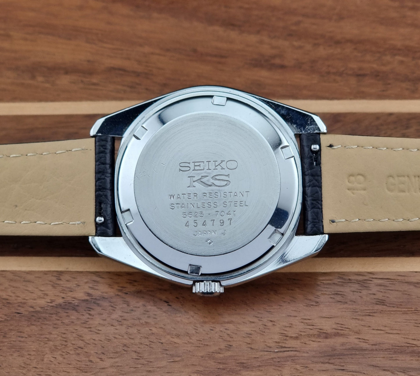 Vintage King Seiko 5625-7041 Wristwatch with black leather strap on a wooden surface case back