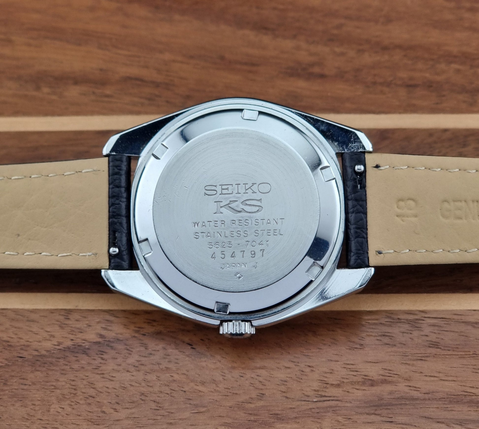 Vintage King Seiko 5625-7041 Wristwatch with black leather strap on a wooden surface case back