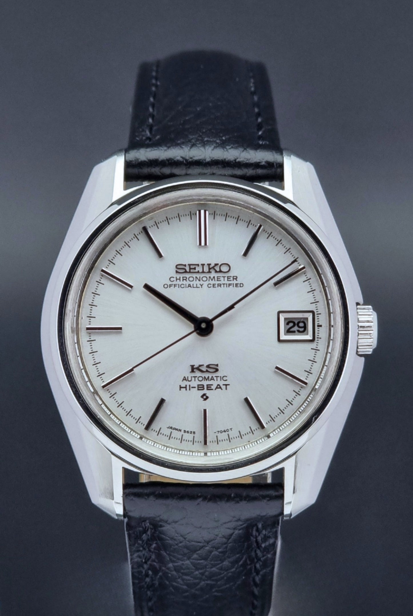 Vintage King Seiko 5625-7041 Wristwatch with black leather strap on a dark surface close up