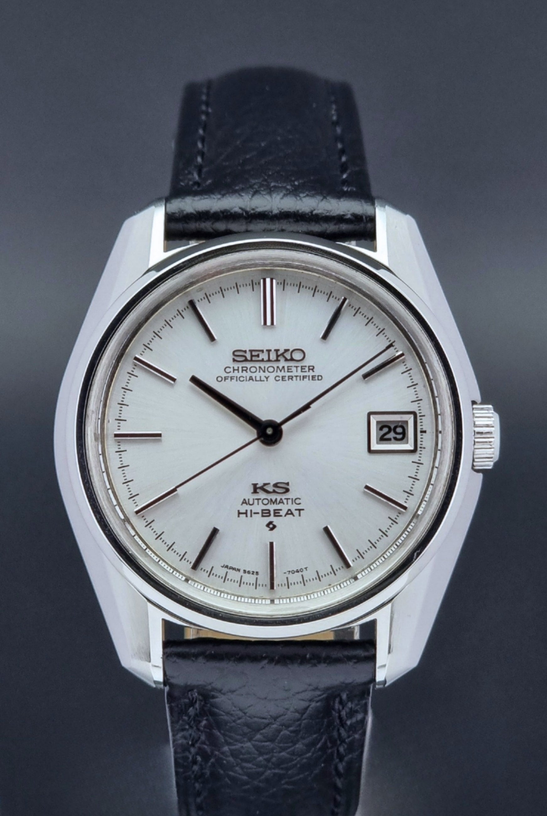 Vintage King Seiko 5625-7041 Wristwatch with black leather strap on a dark surface close up