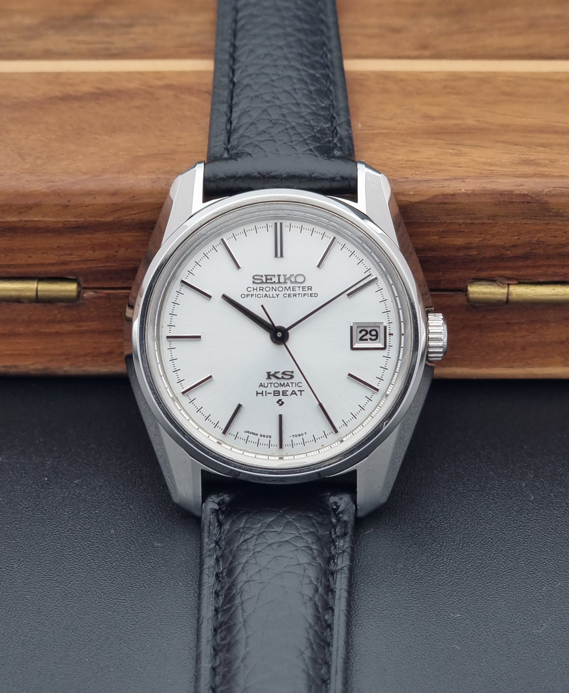 Vintage King Seiko 5625-7041 Wristwatch with black leather strap on a wooden surface front