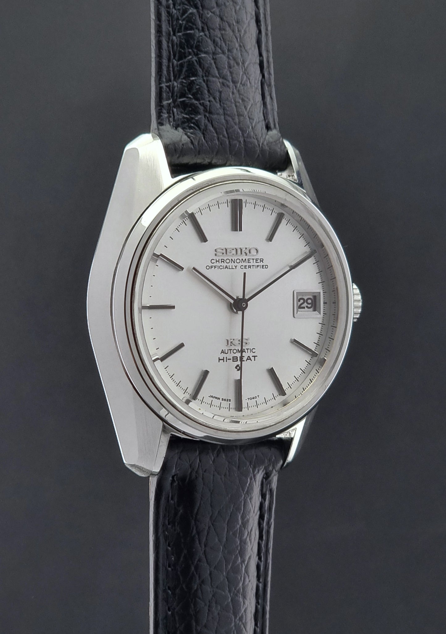 Vintage King Seiko 5625-7041 Wristwatch with black leather strap on a dark surface side profile