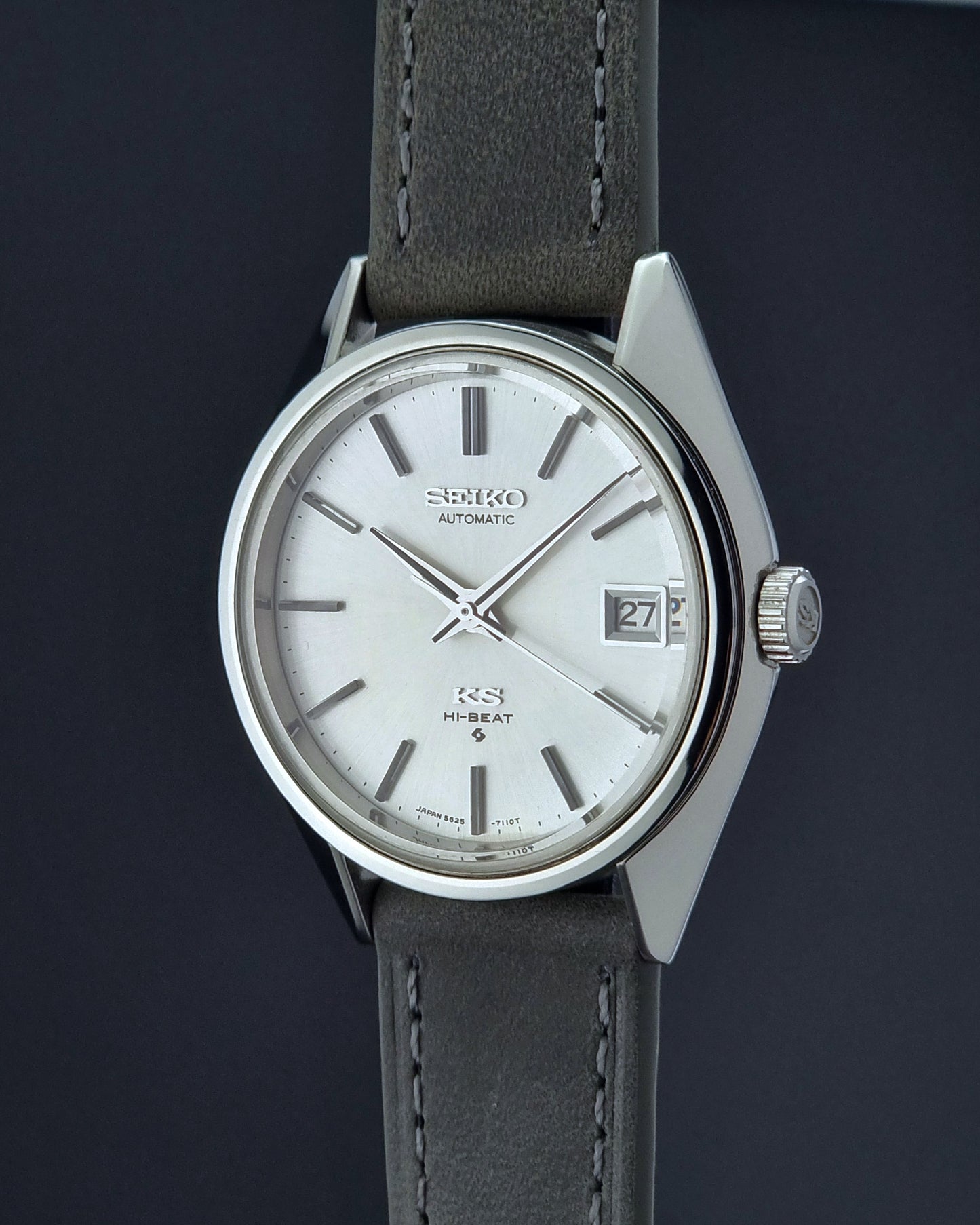 Vintage King Seiko watch with gray strap and silver case on a dark background