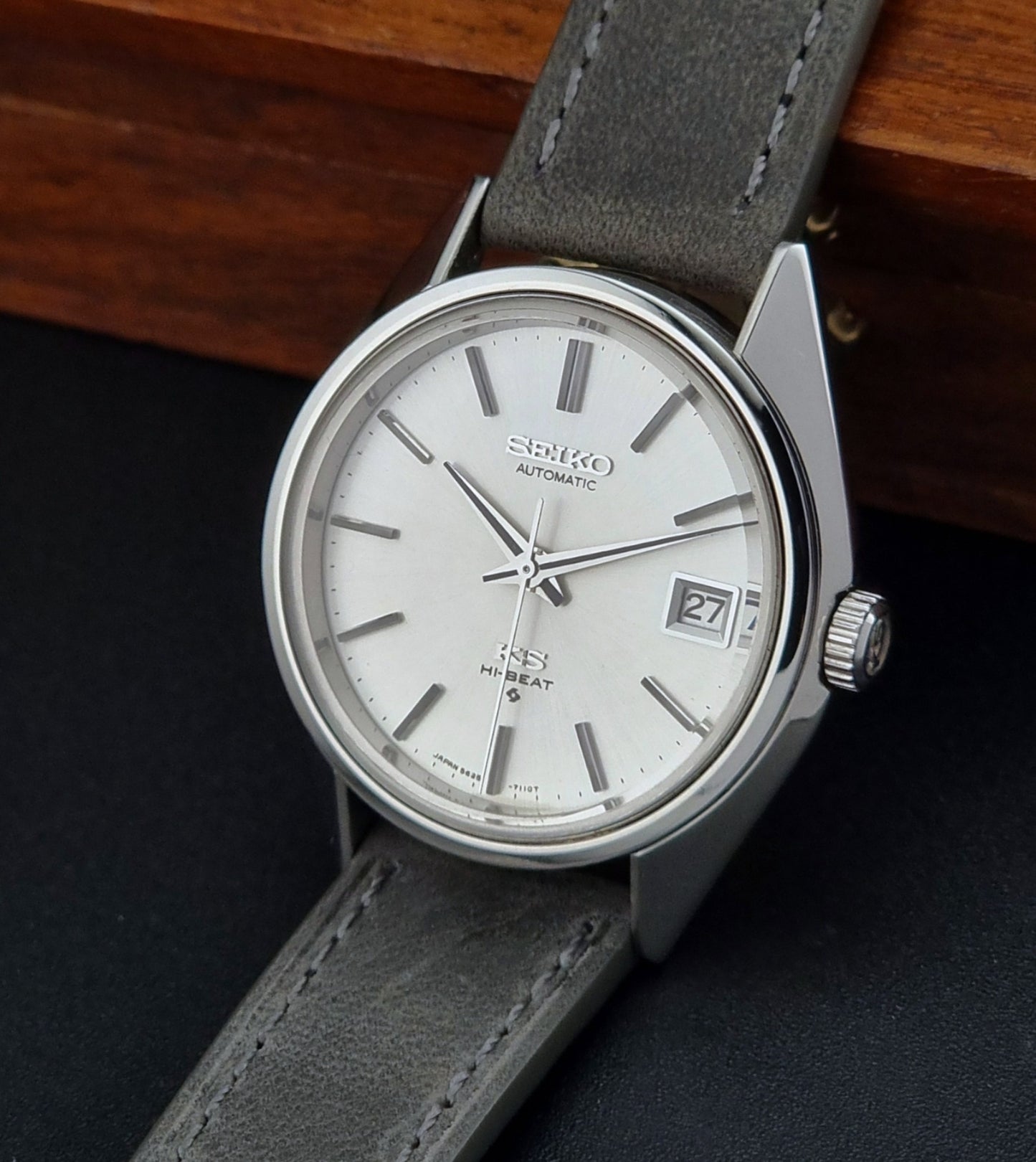 Vintage King Seiko watch with gray strap on a dark background