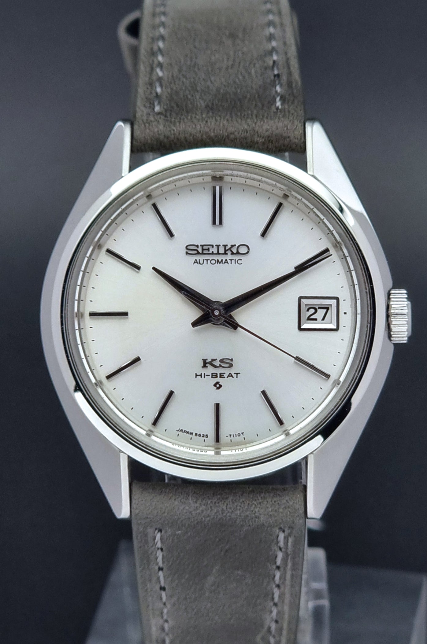 Vintage King Seiko watch with gray leather strap on a dark background