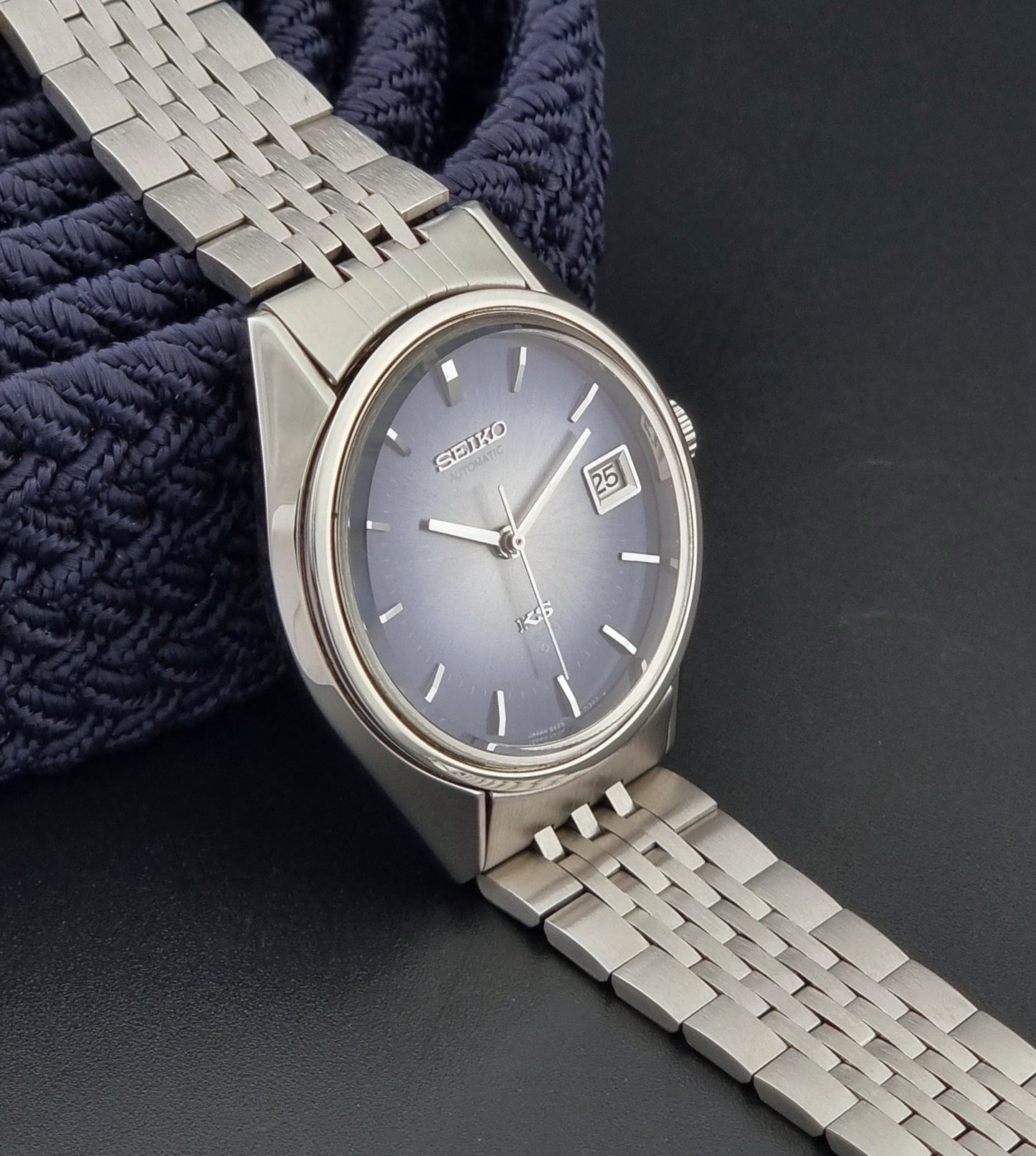 King Seiko watch with a blue dial with a textured strap on a dark background