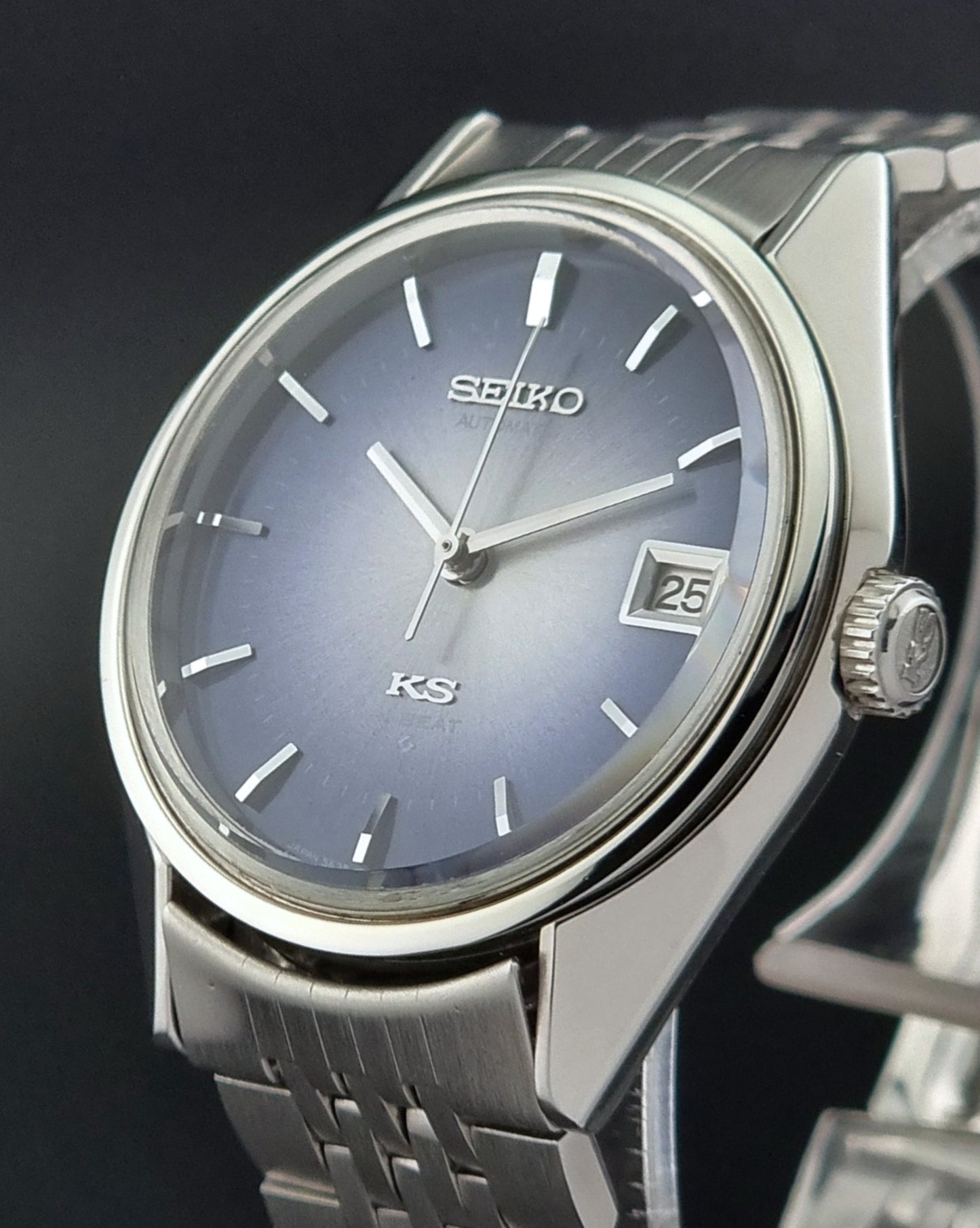 King Seiko watch with a blue dial and silver metal strap on a dark background