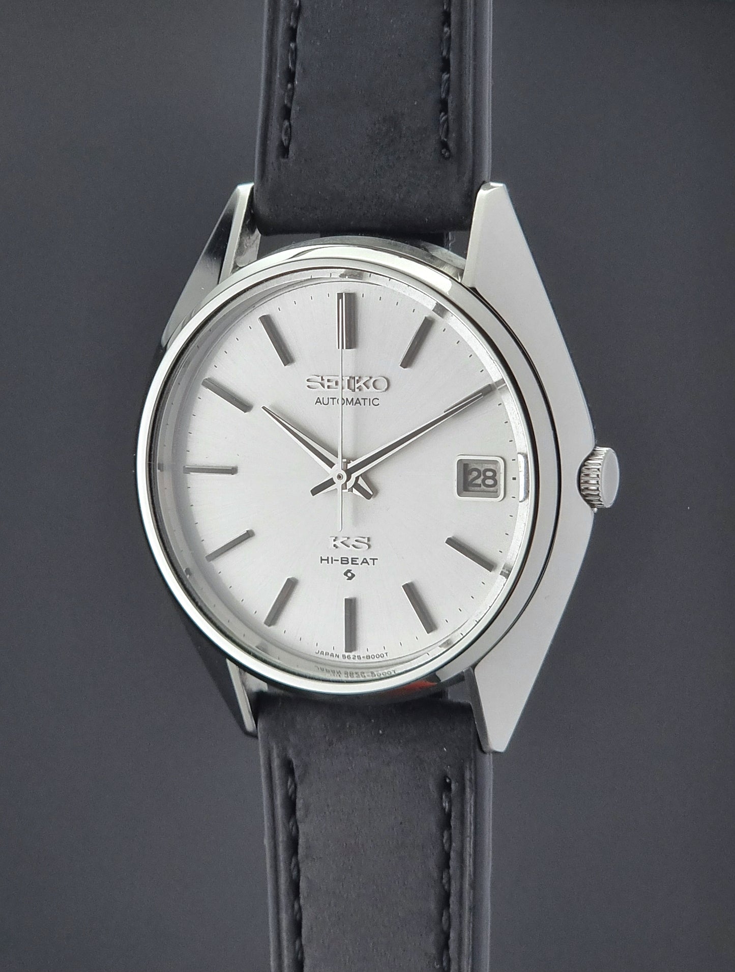 Vintage King Seiko watch with black leather strap on a dark background