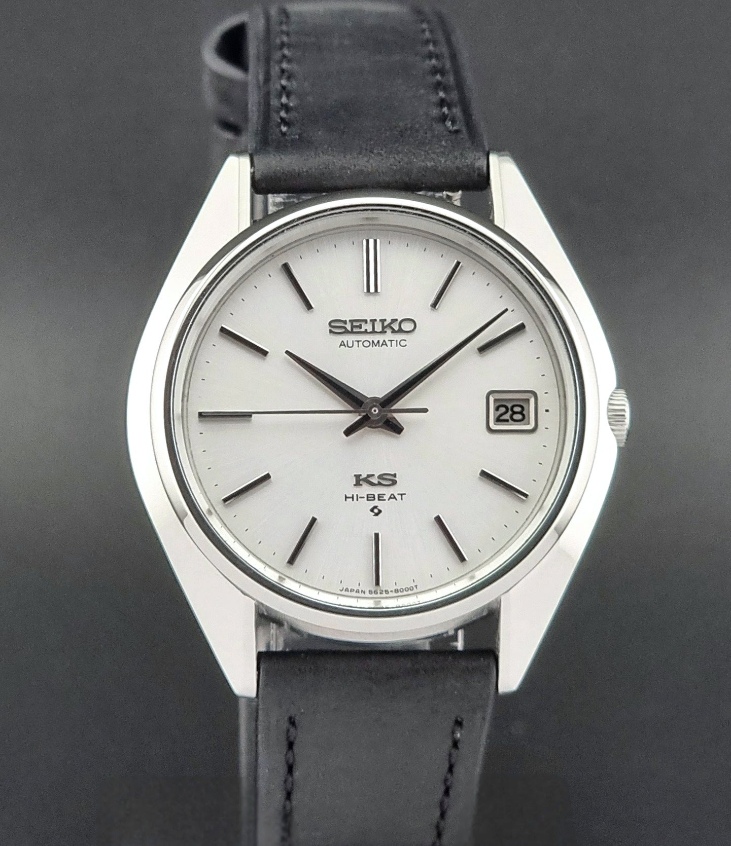 Vintage King Seiko watch with black leather strap on a dark background