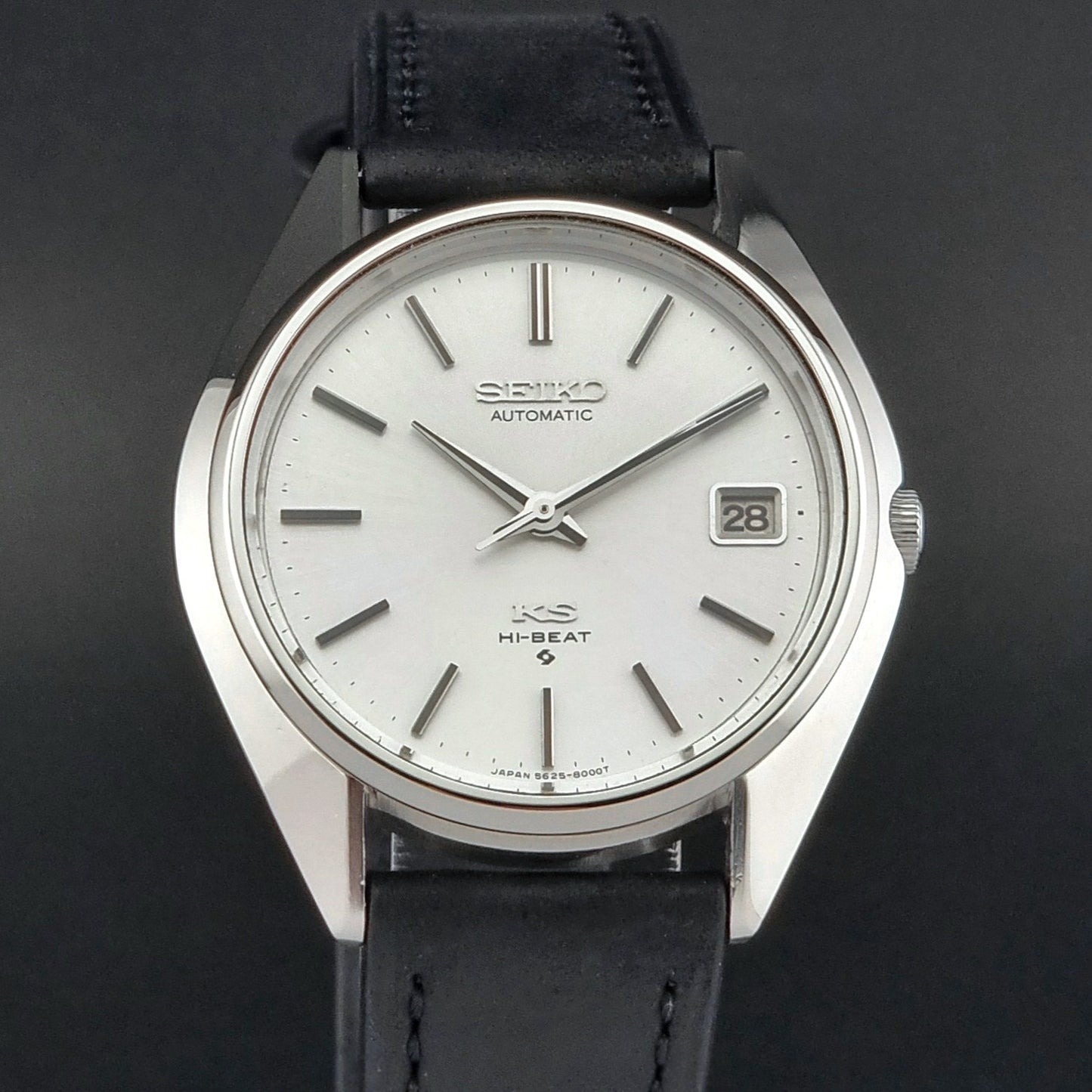 Vintage King Seiko watch with black leather strap on a dark background