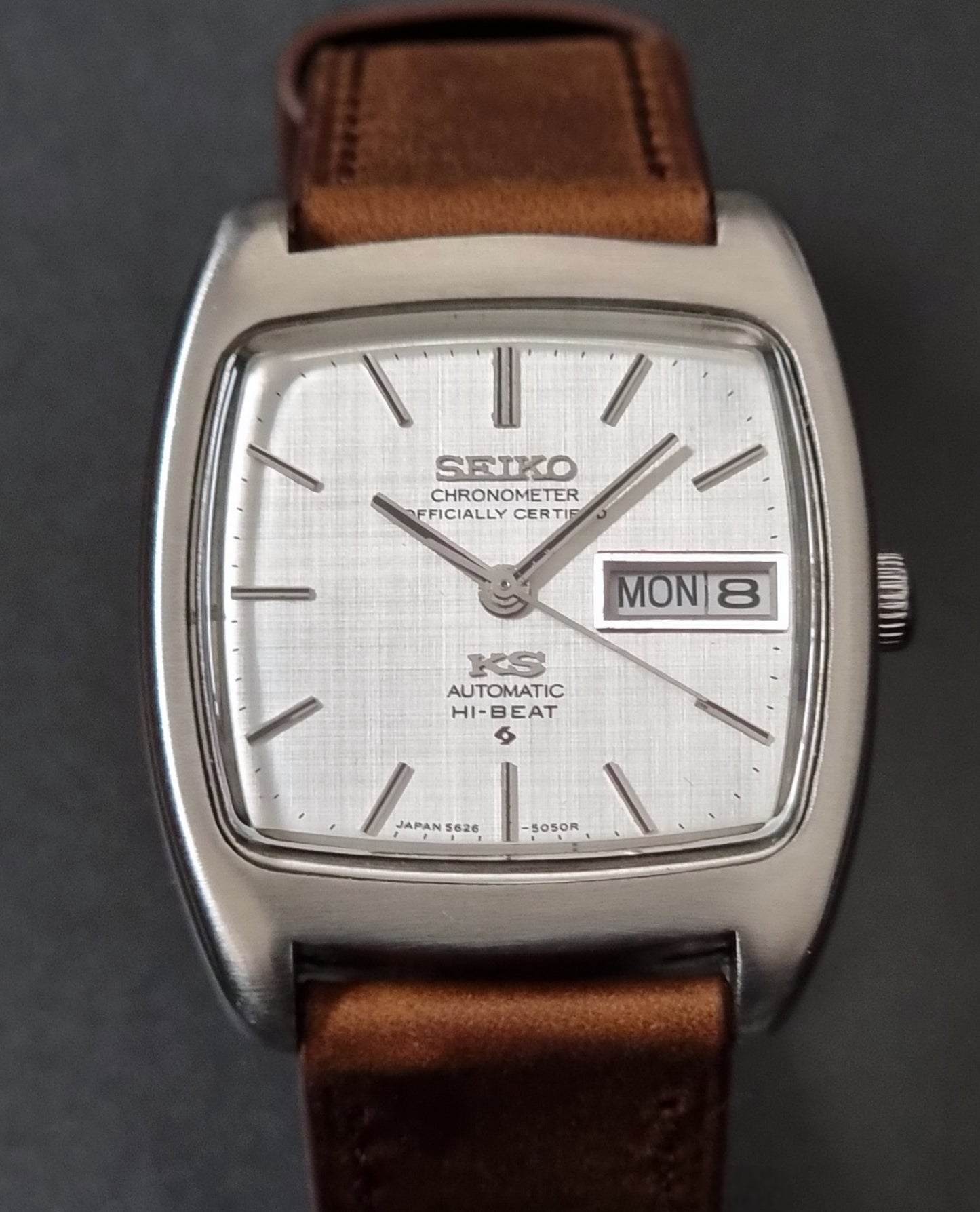 Vintage King Seiko 5626-5040 watch with brown leather strap on a textured gray background