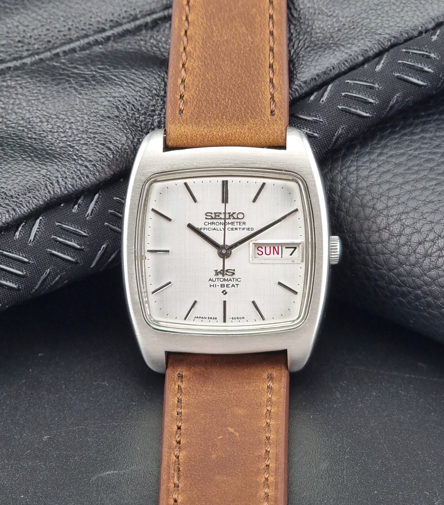 Vintage King Seiko 5626-5040 watch with brown leather strap on a textured gray background