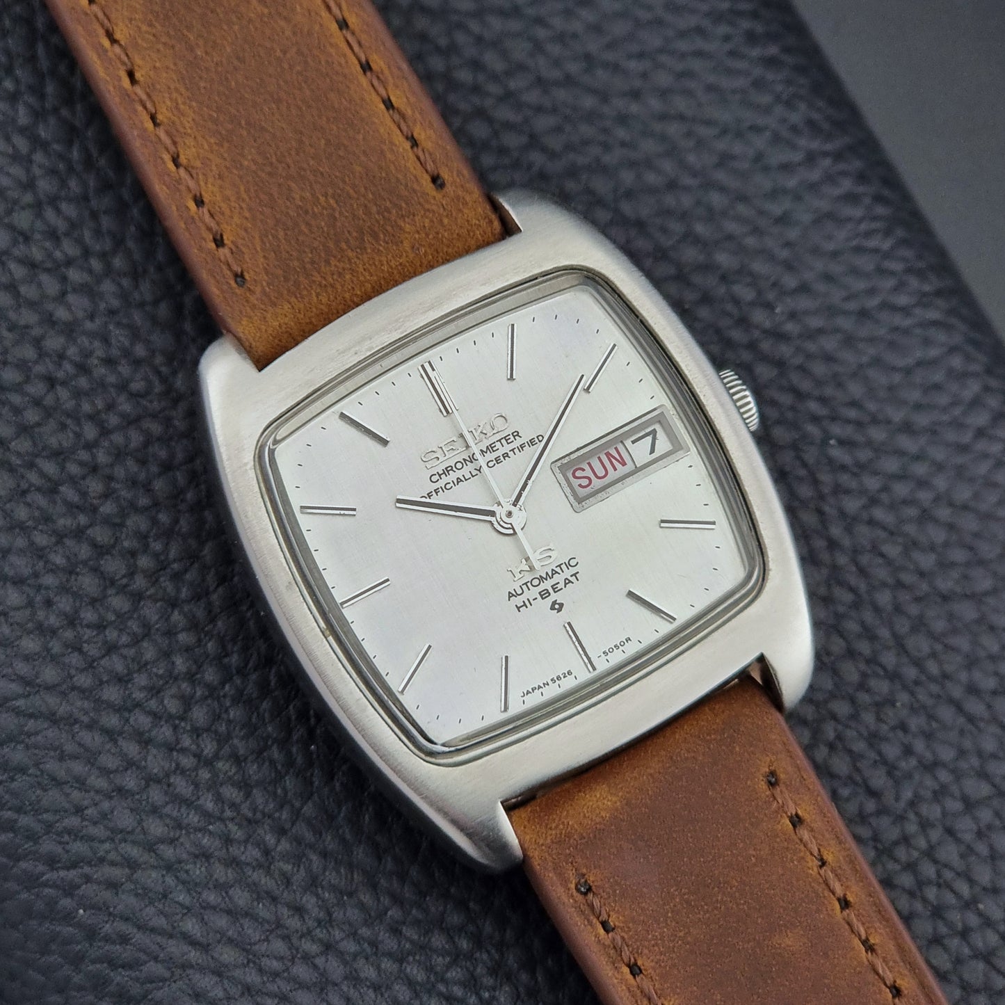 Vintage King Seiko 5626-5040 watch with brown leather strap on a textured gray background