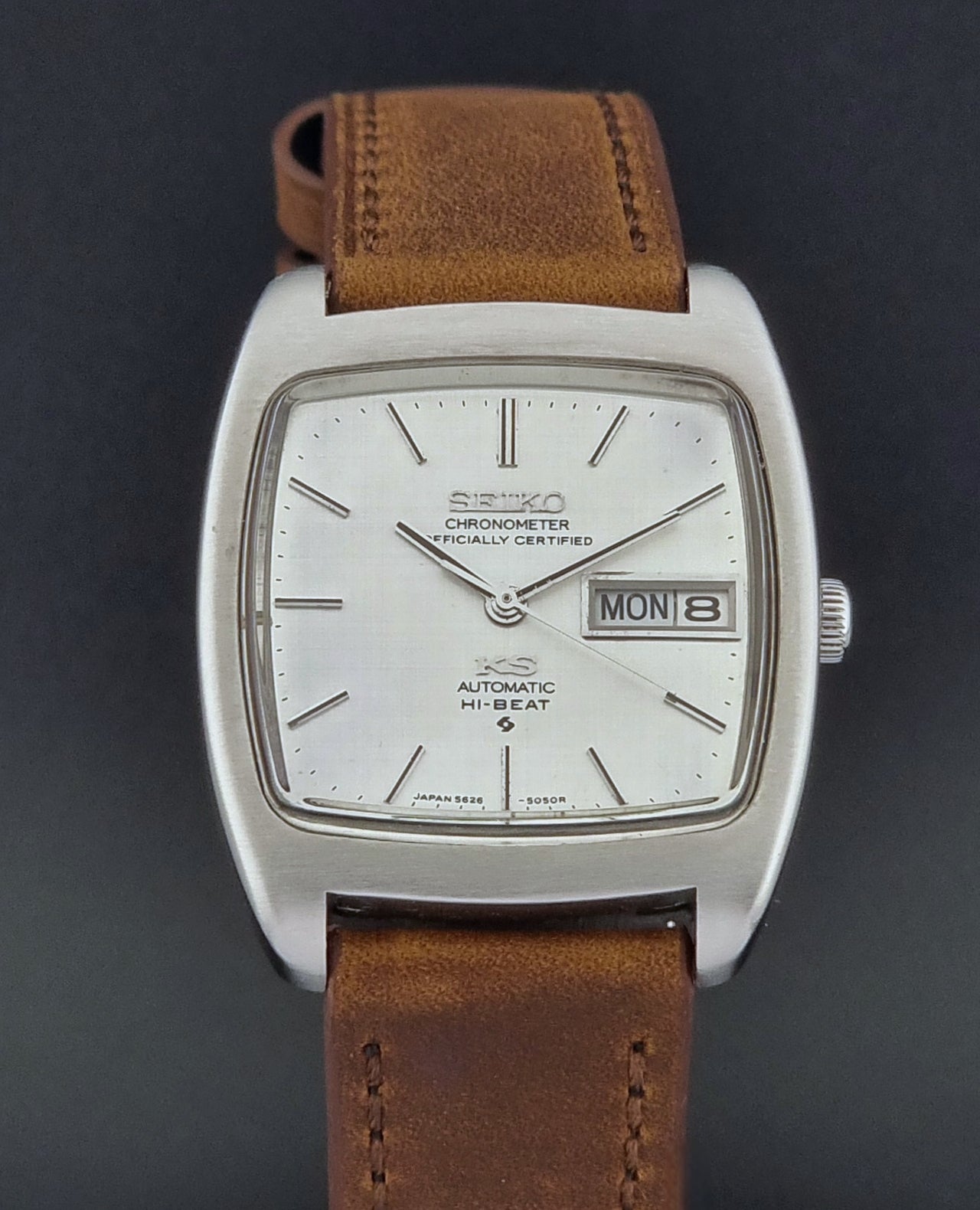 Vintage King Seiko 5626-5040 watch with brown leather strap on a textured gray background