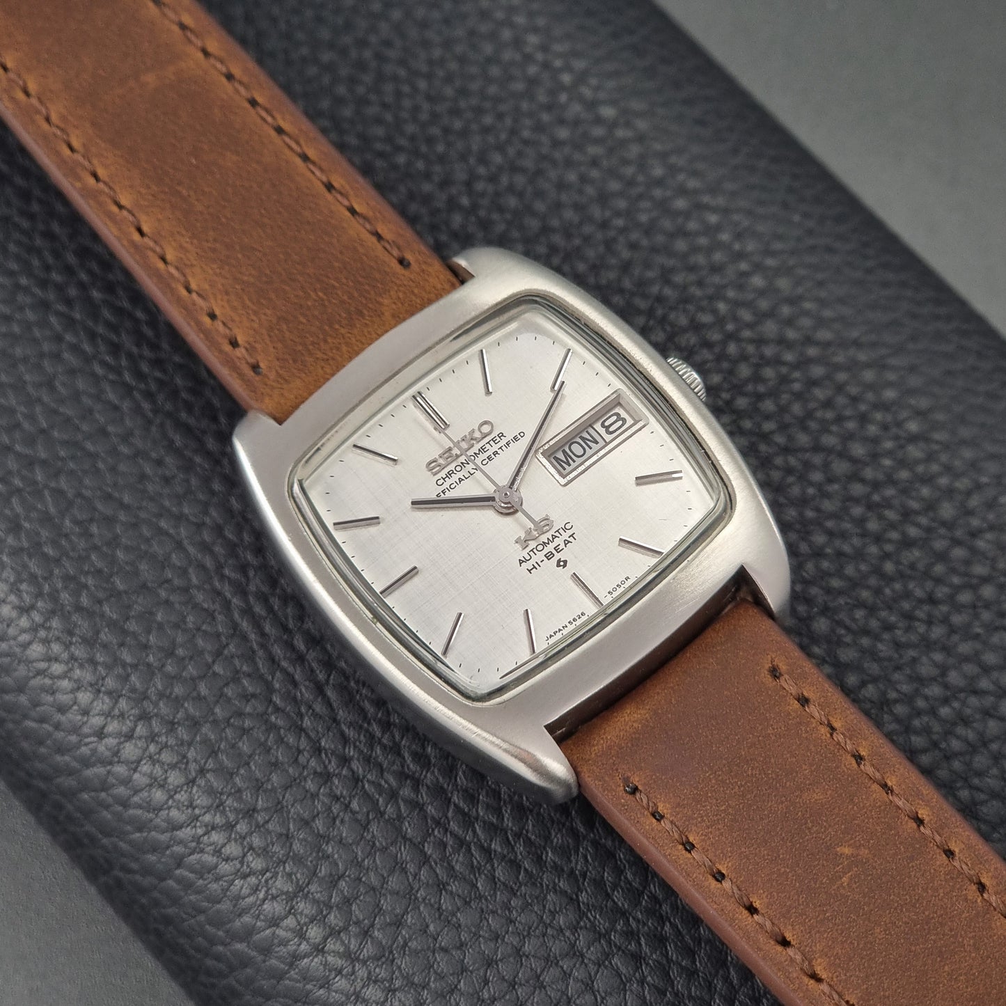 Vintage King Seiko 5626-5040 watch with brown leather strap on a textured gray background