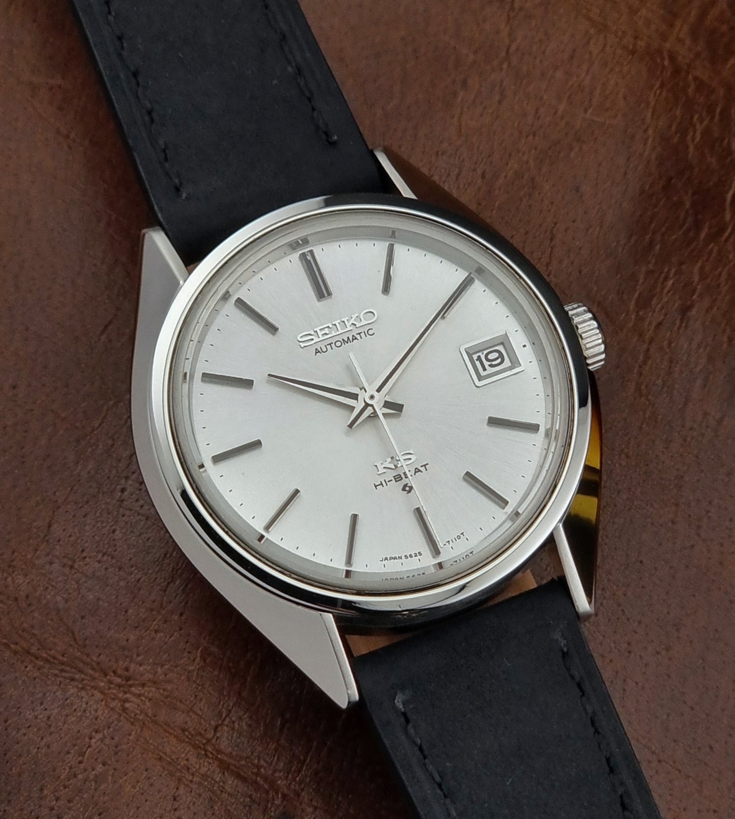 Vintage King Seiko watch with a white dial on a brown background