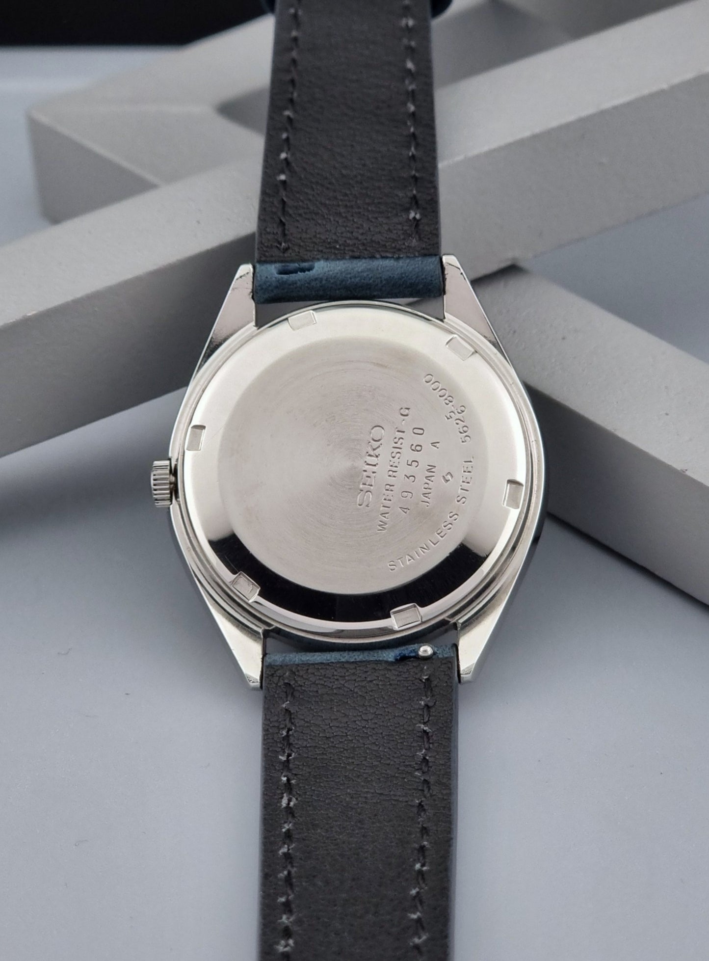 Vintage King Seiko Wristwatch 5626-8000 with a blue leather strap on a grey background case back