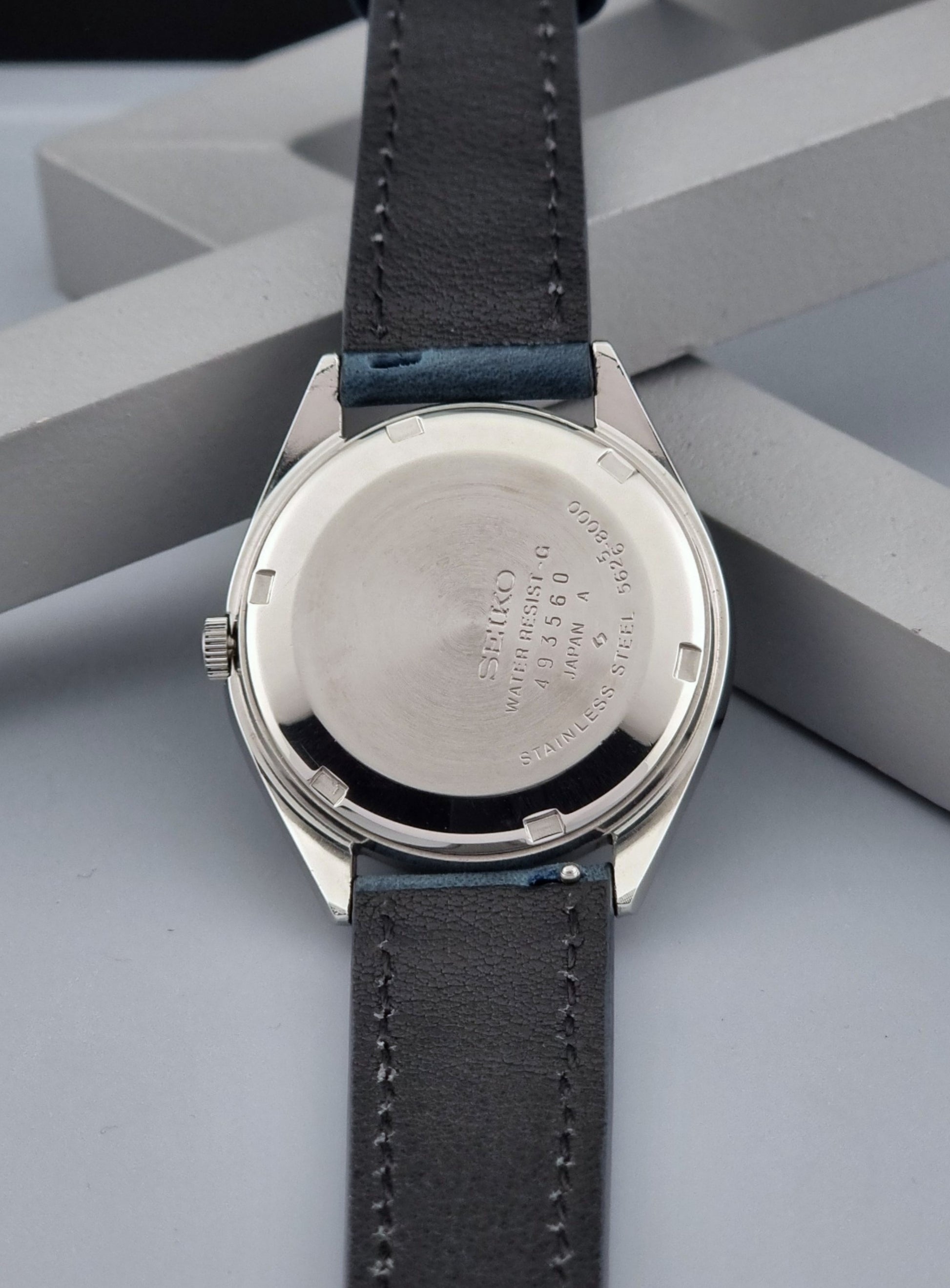Vintage King Seiko Wristwatch 5626-8000 with a blue leather strap on a grey background case back