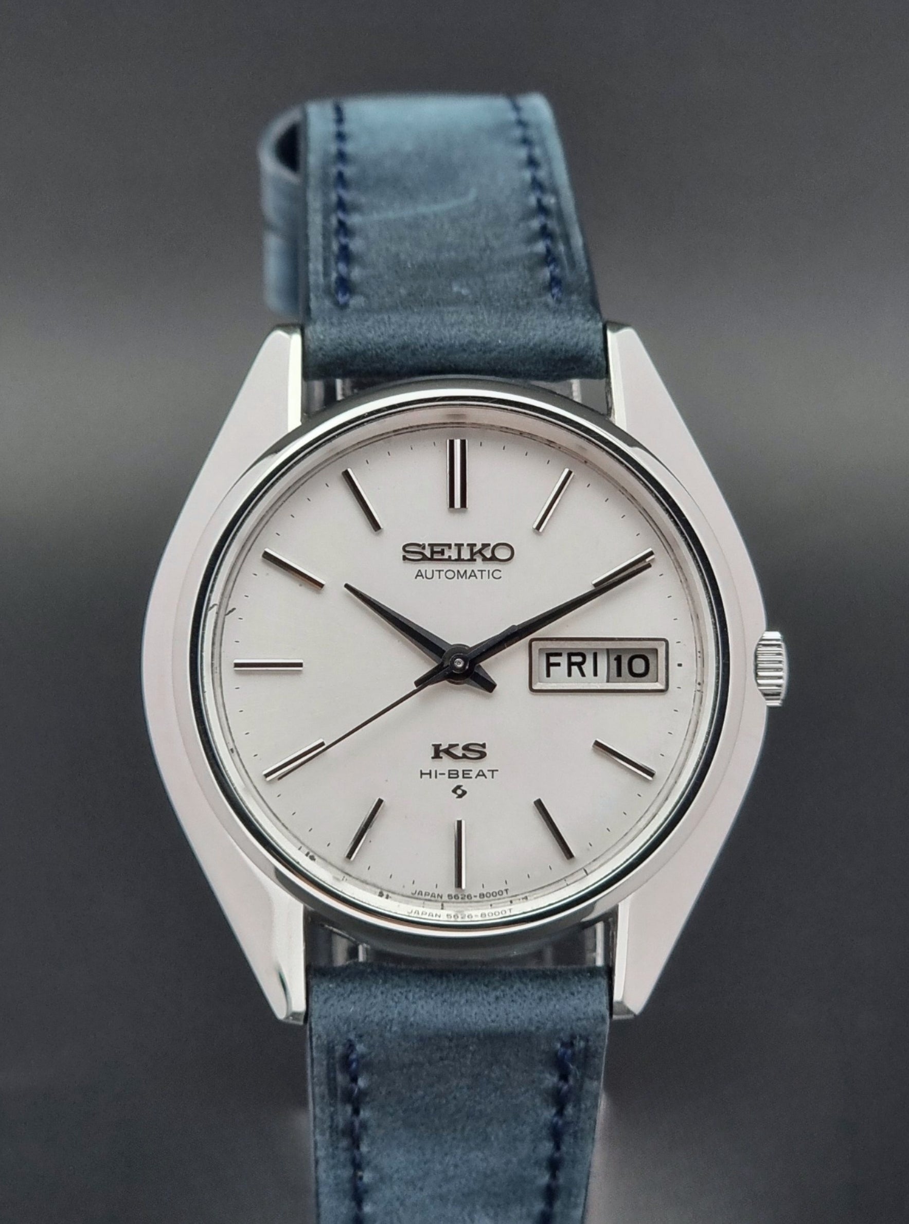 Vintage King Seiko Wristwatch 5626-8000 with a blue leather strap on a grey background front view