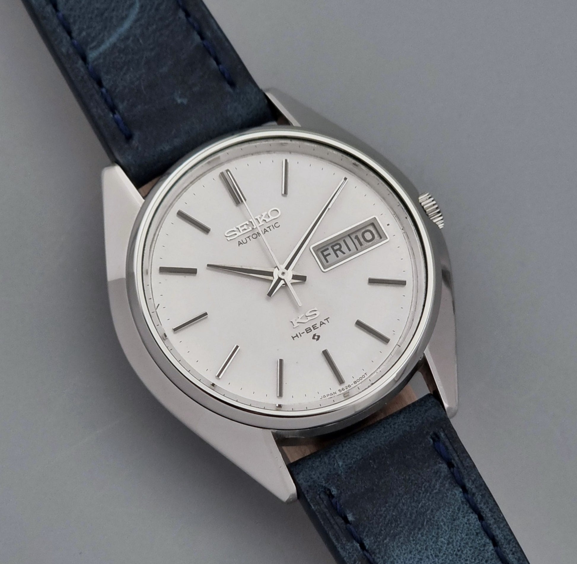 Vintage King Seiko Wristwatch 5626-8000 with a blue leather strap on a grey background close up