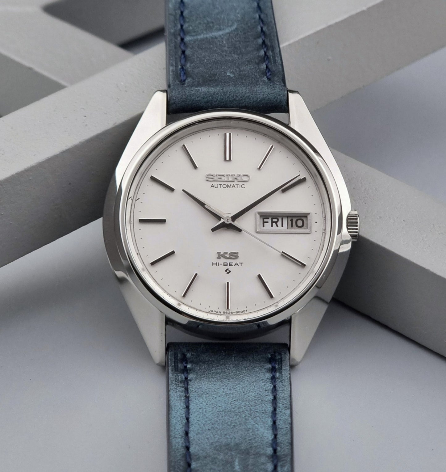 Vintage King Seiko Wristwatch 5626-8000 with a blue leather strap on a grey background front