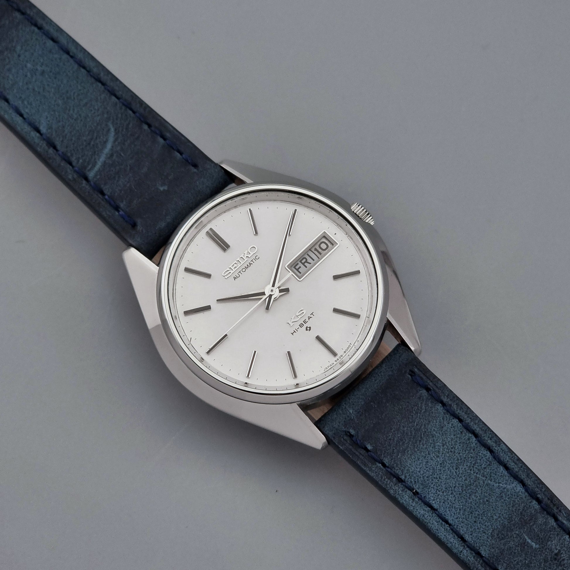 Vintage King Seiko Wristwatch 5626-8000 with a blue leather strap on a grey background