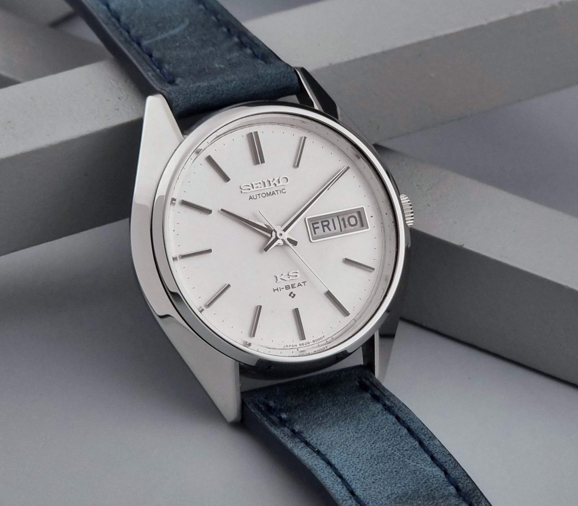 Vintage King Seiko Wristwatch 5626-8000 with a blue leather strap on a grey background side