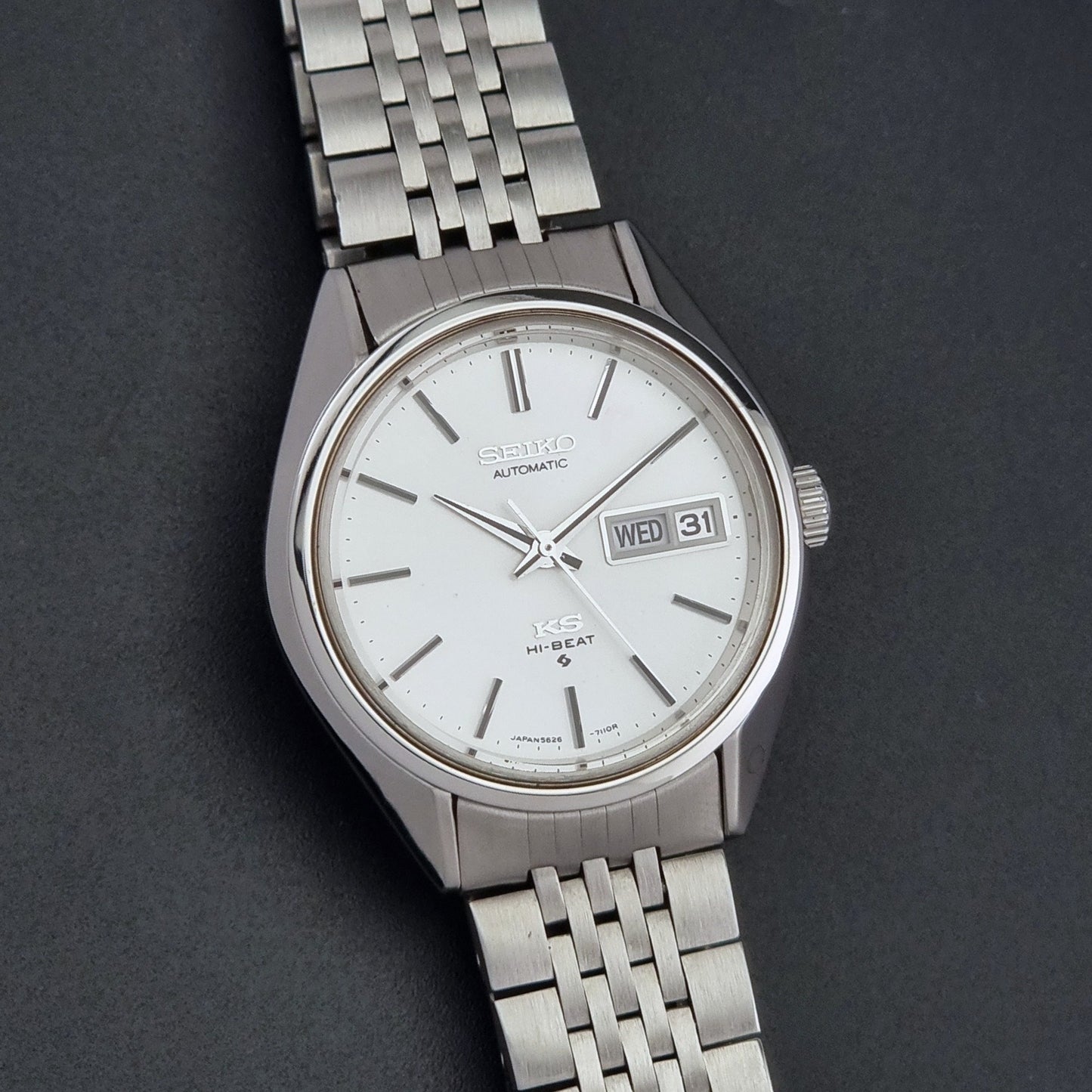 Vintage King Seiko 5626-7111 Wristwatch with white dial on a dark background close up dial view