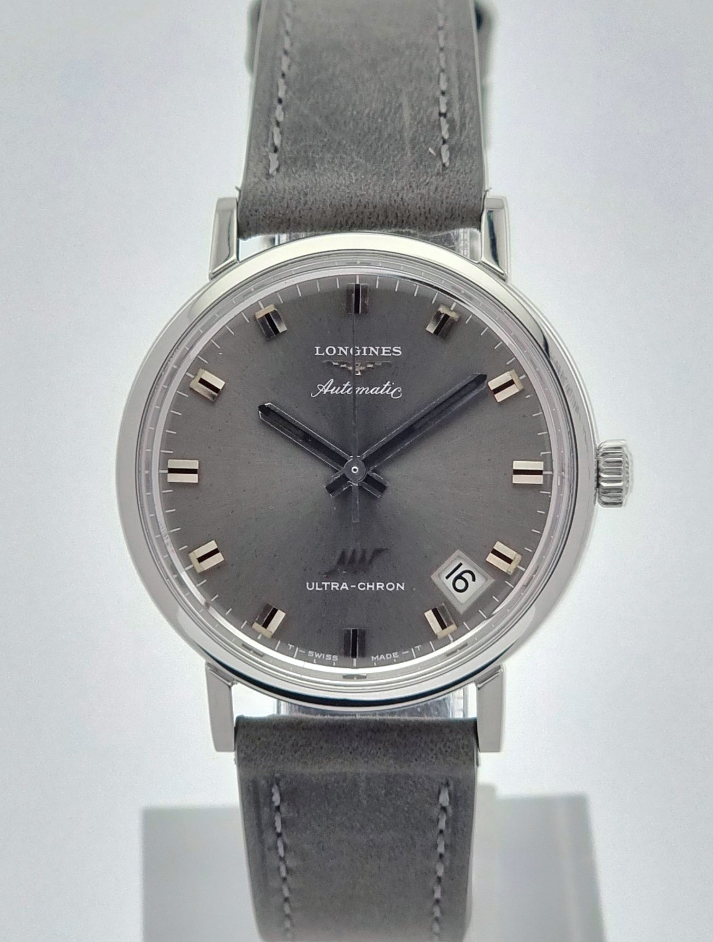 Vintage Longines Ultra-Chron watch with gray strap and face on a white background