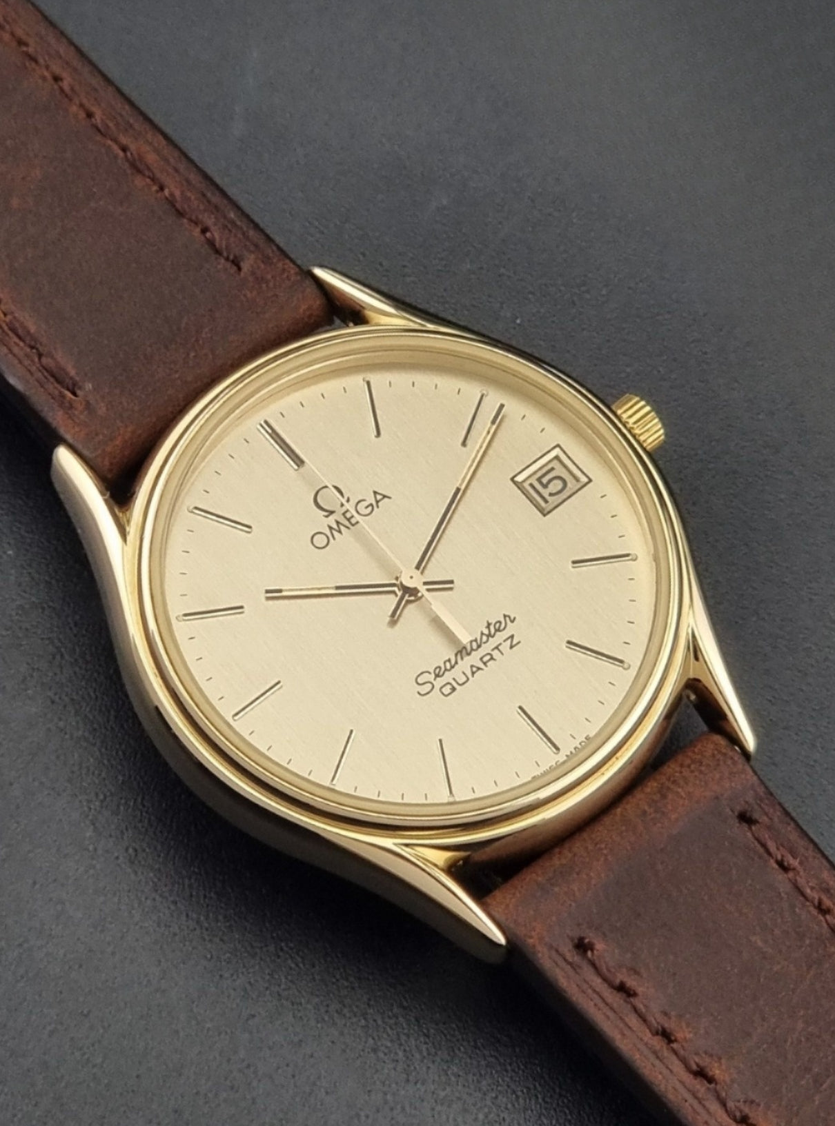 Vintage Omega Quartz Seamaster 196.0281 Wristwatch in a gold case close front view