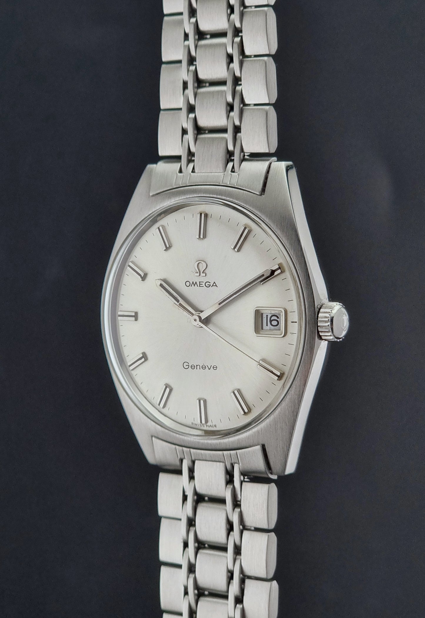 Silver Vintage Omega Geneve watch with a dark background