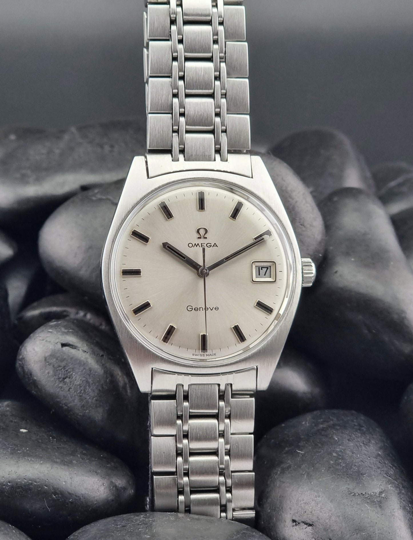 Silver Vintage Omega Geneve watch on dark stones