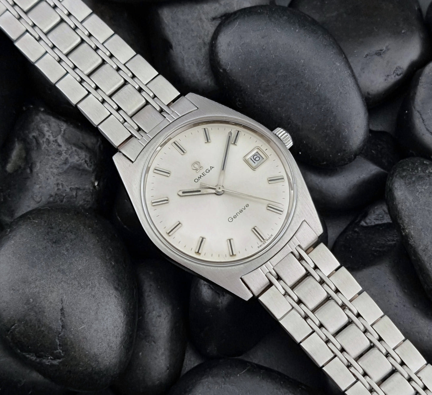 Vintage Omega Geneve watch on pebbles