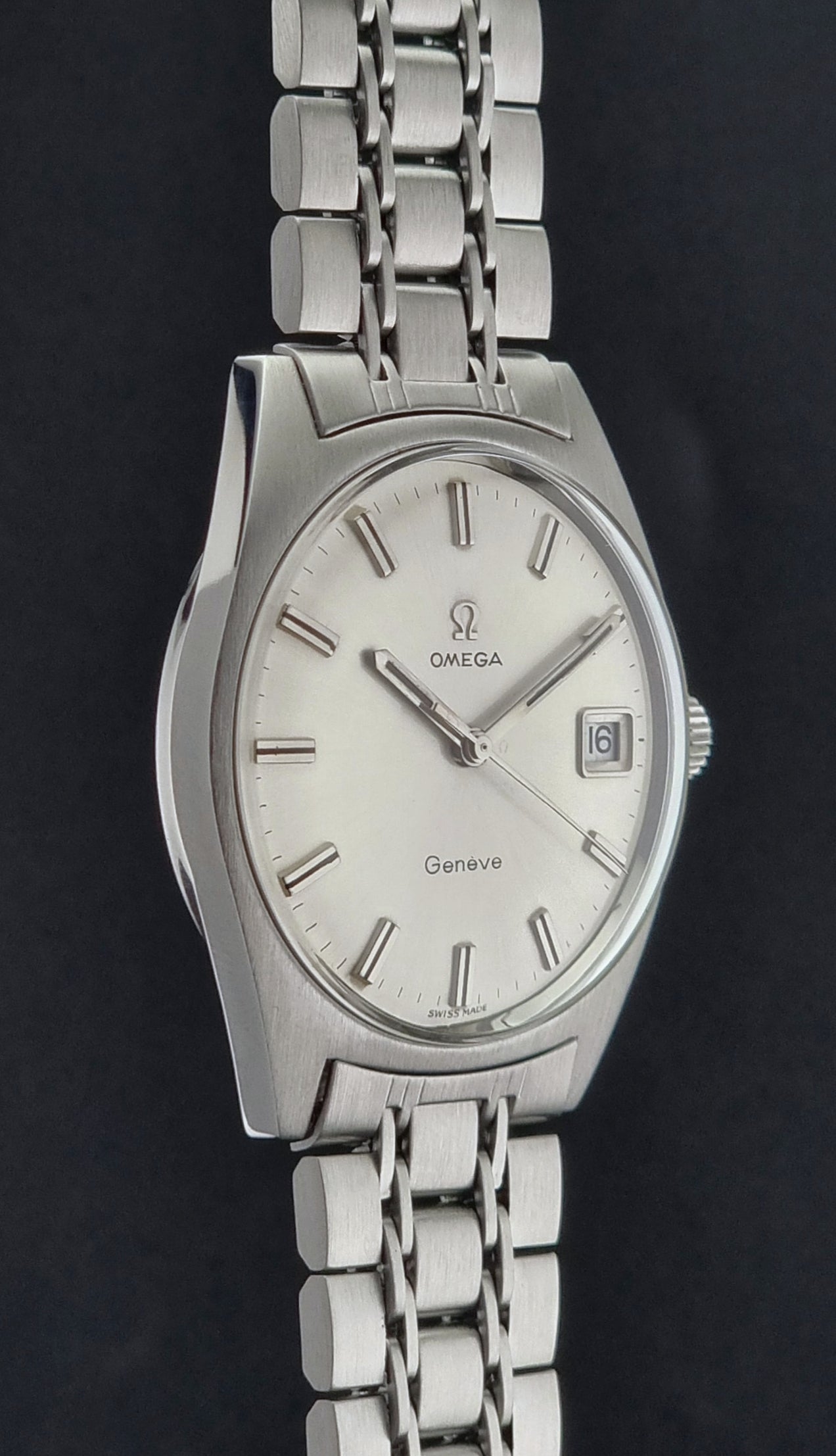 Side view of a Vintage Omega Geneve watch with a dark background