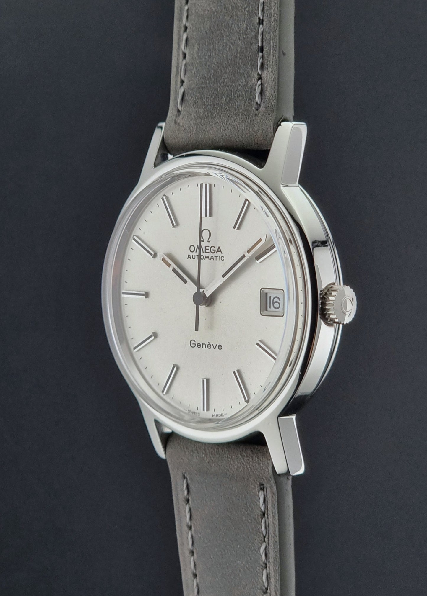 Vintage Omega watch with gray strap on a dark background