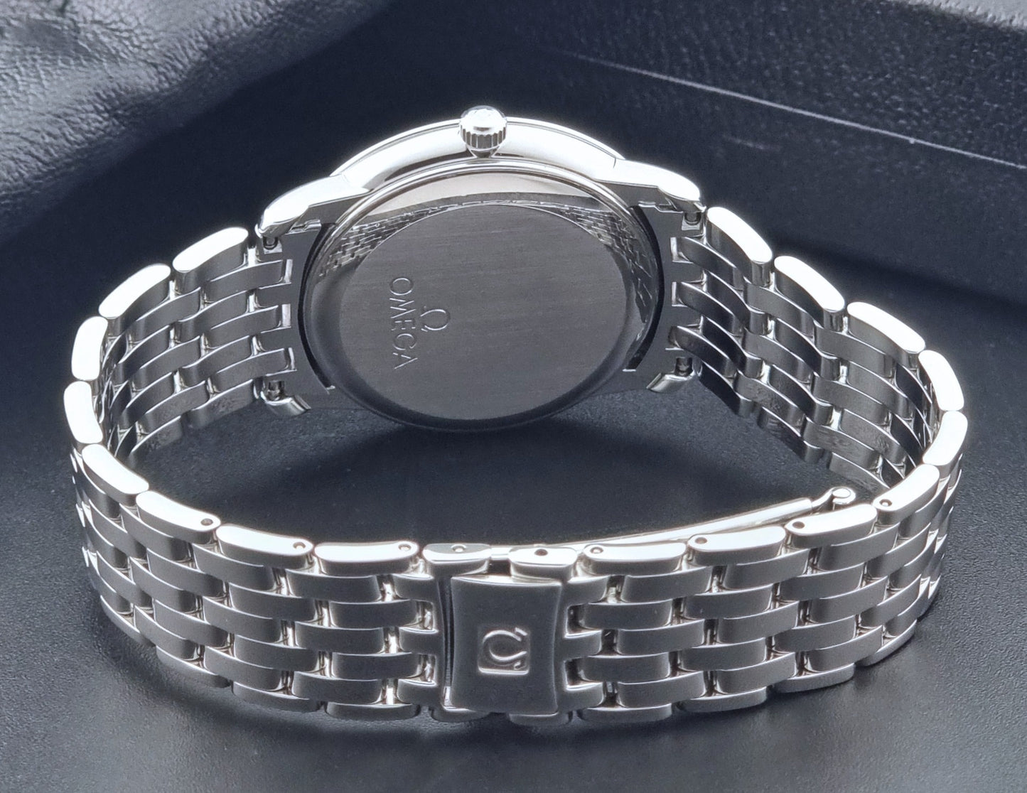 Omega watch a De-Ville Prestige 168.1050 with a stainless steel bracelet on a dark background bracelet view