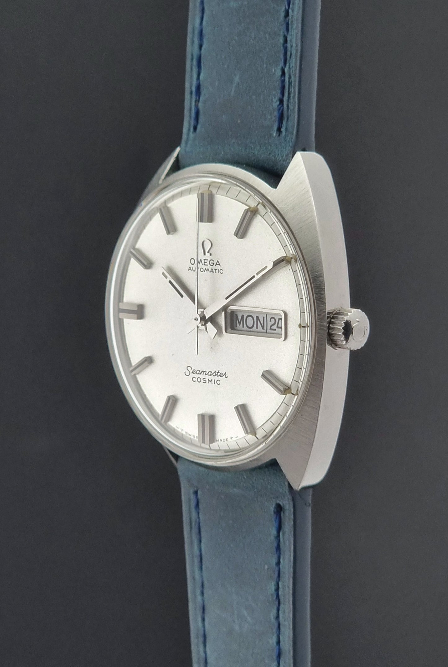 Vintage Omega Seamaster Cosmic with blue strap on a dark background