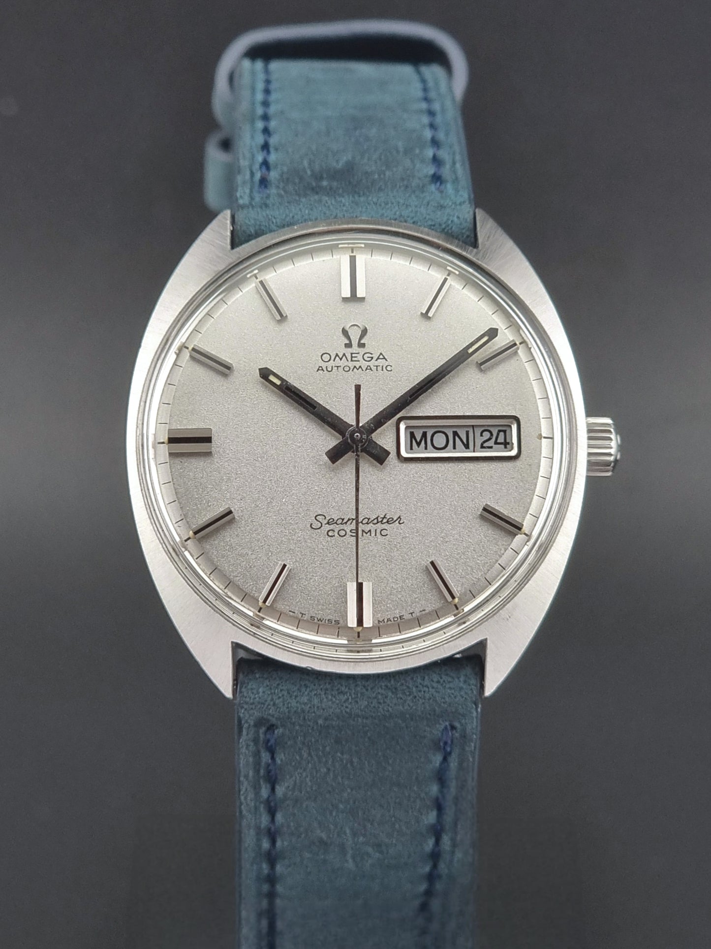 Vintage Omega Seamaster Cosmic watch with blue strap on a dark background