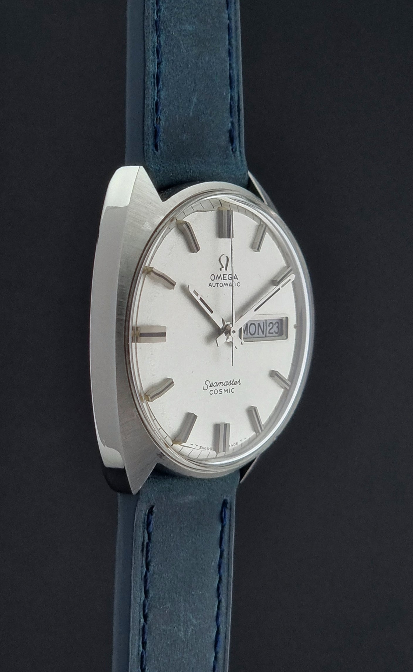 Vintage Omega Seamaster Cosmic watch with blue strap on a black background