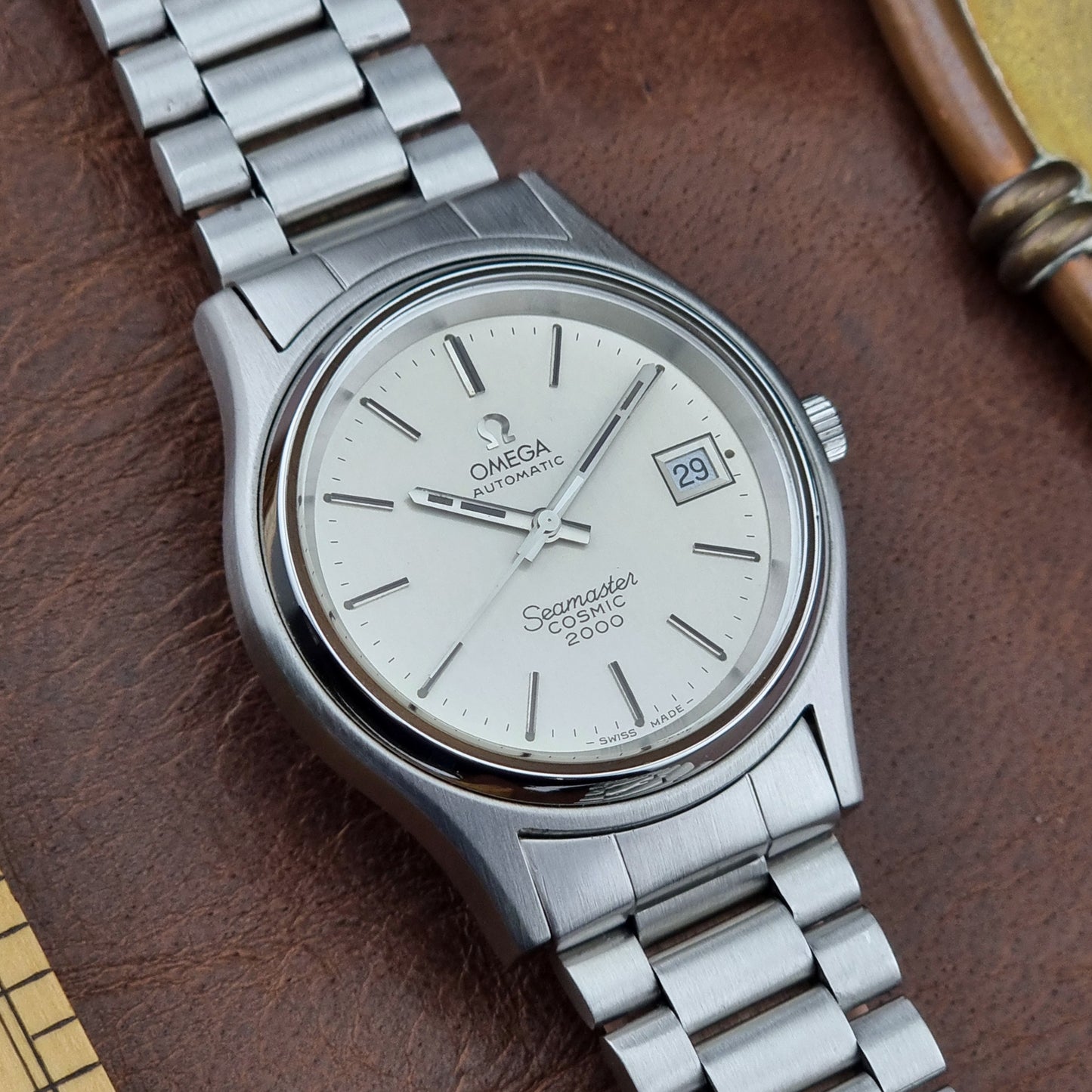 Vintage Omega Seamaster watch on a brown leather surface