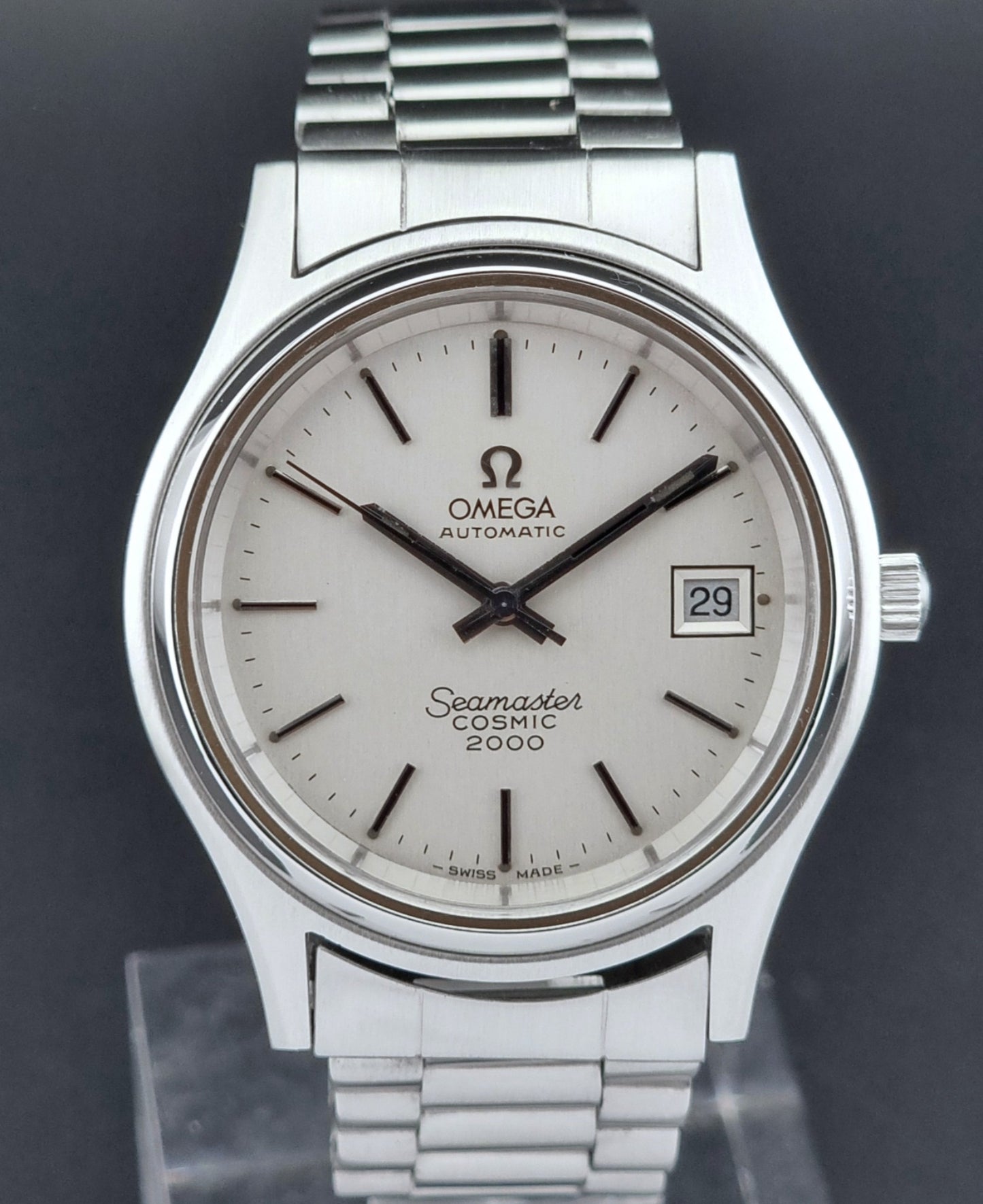 Silver Omega Seamaster Cosmic 2000 watch on a dark background