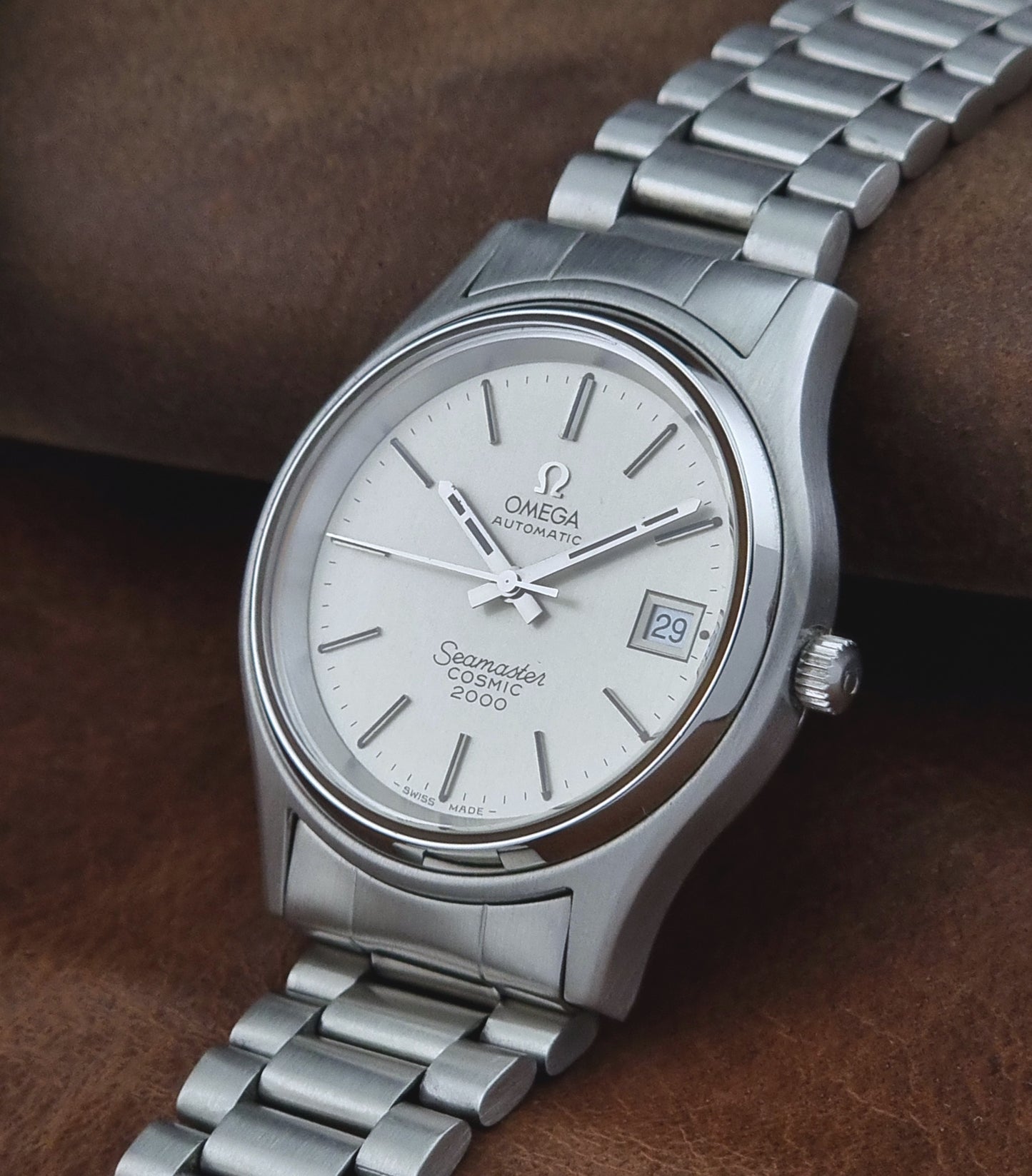 Vintage Omega Seamaster watch on a brown leather background