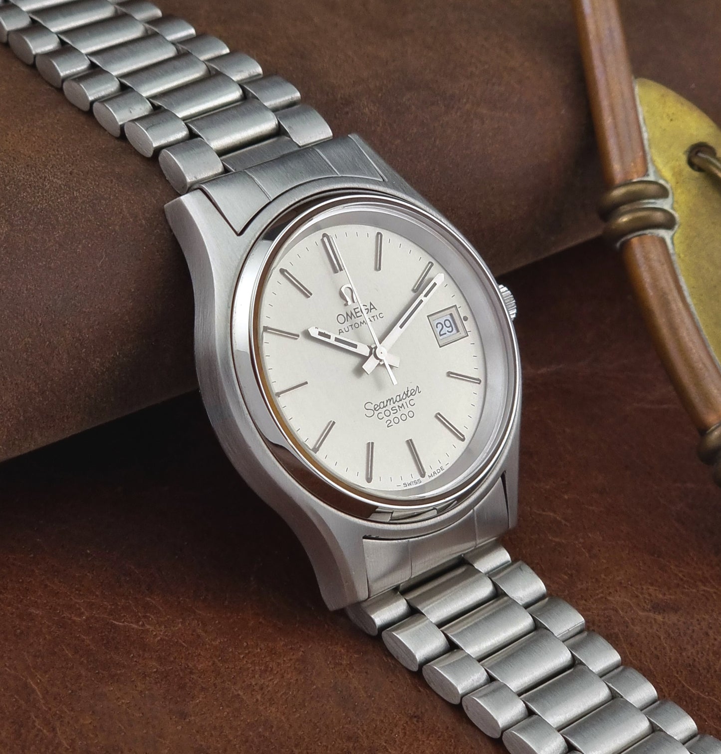 Vintage Omega Seamaster watch on a brown leather surface