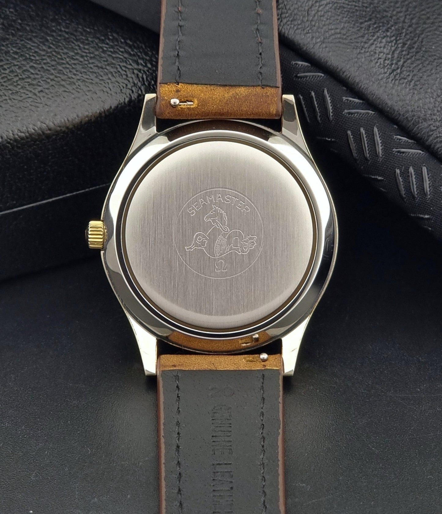 Vintage Omega Wristwatch Seamaster Cosmic 2000 Jumbo 166.129 watch with brown leather strap on a gray surface case back view