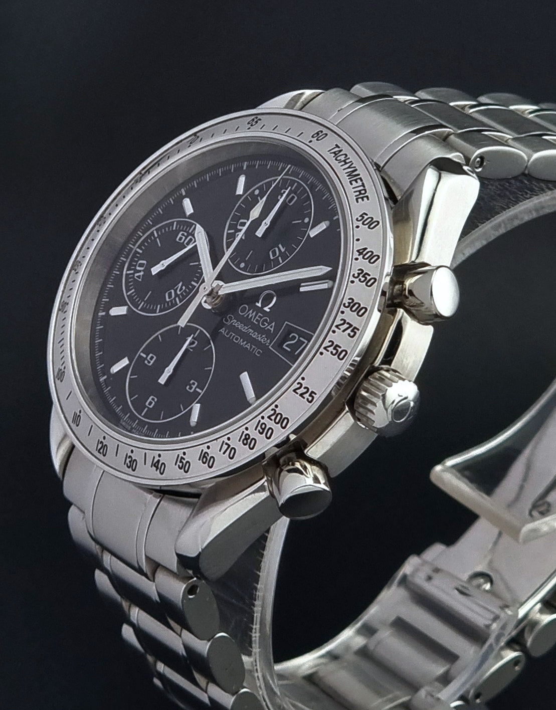 Omega Speedmaster watch with a dark face on a black background