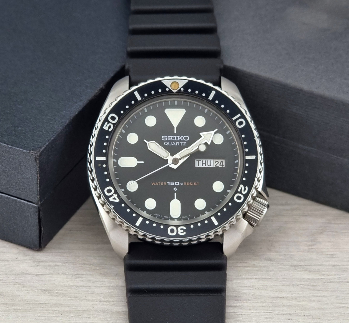 Seiko Quartz Dive watch 7548-7000 with a detailed face on a gray surface
