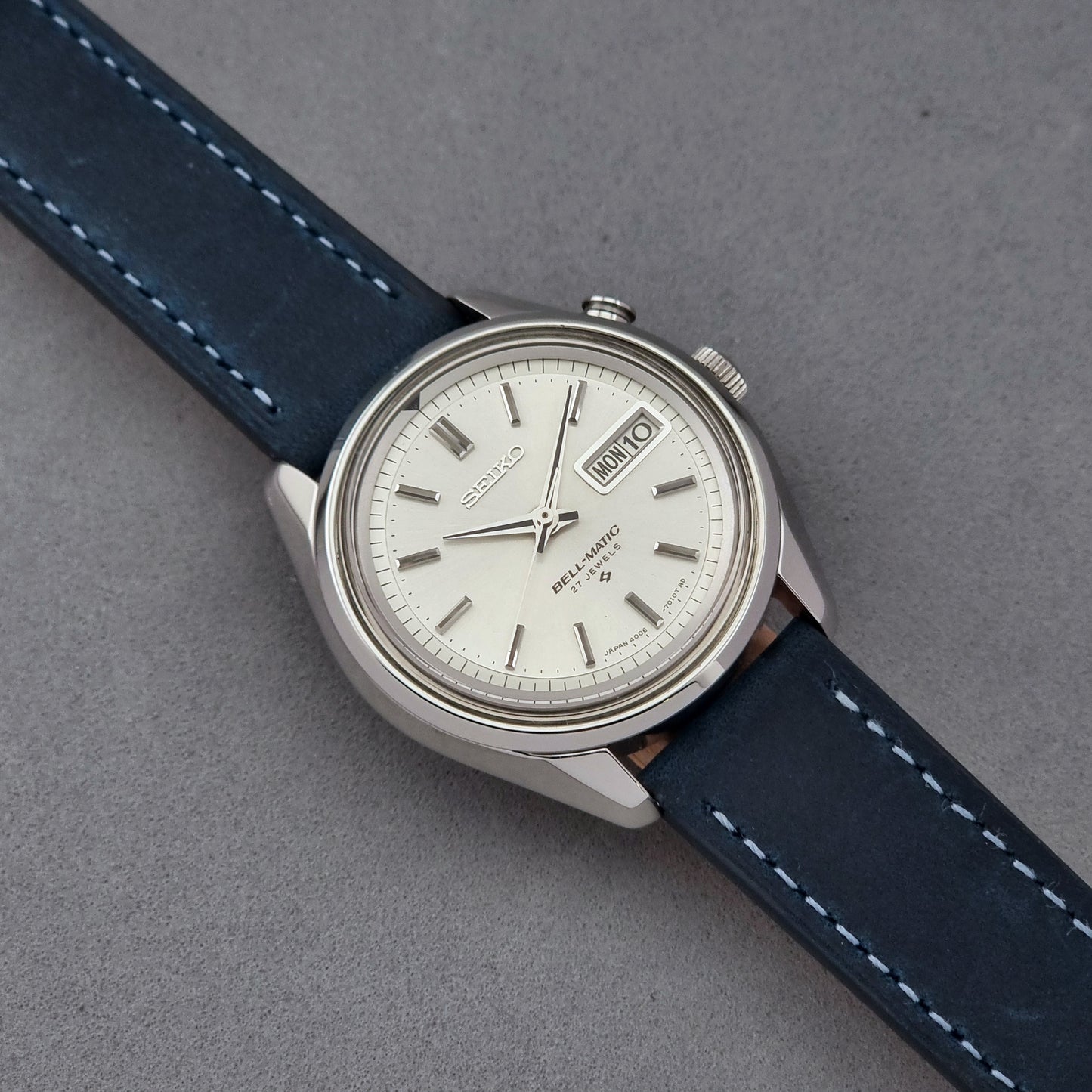 Vintage Seiko Alarm Watch Bell-Matic 4006-7010 with a blue strap on a grey background