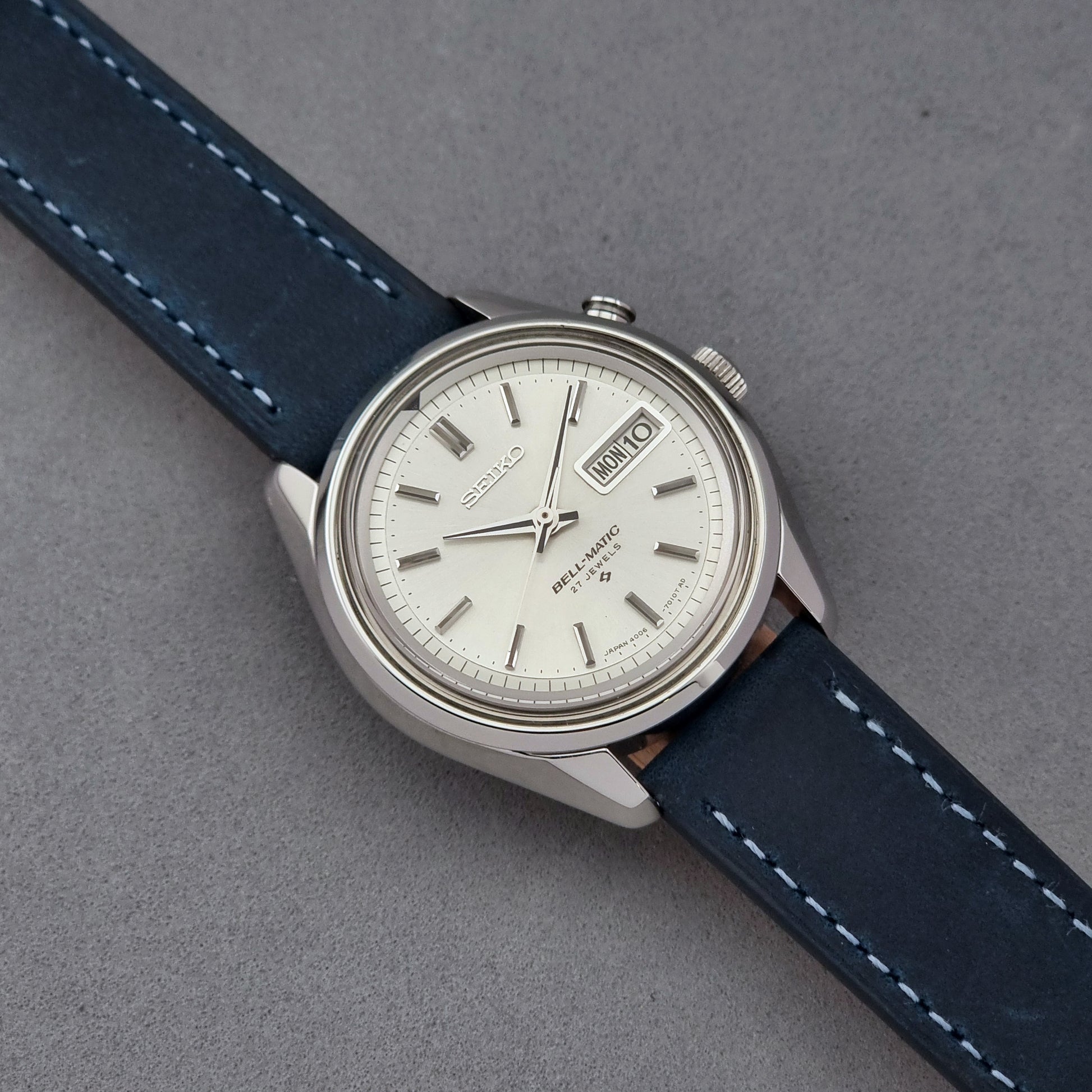 Vintage Seiko Alarm Watch Bell-Matic 4006-7010 with a blue strap on a grey background