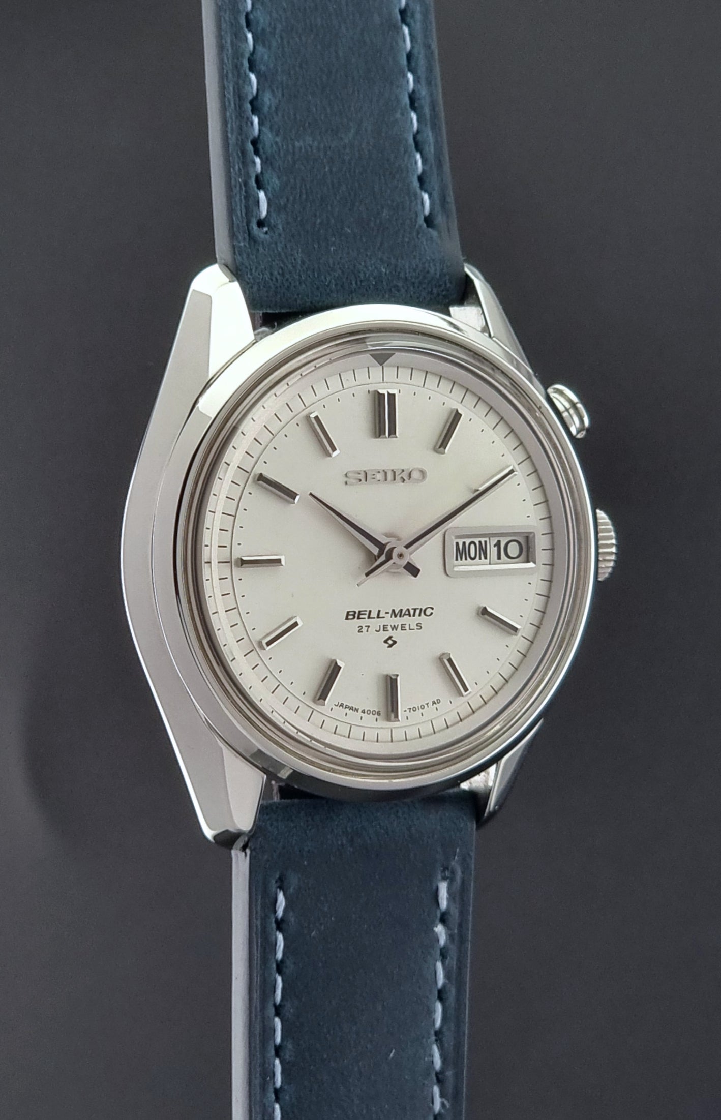 Vintage Seiko Alarm Watch Bell-Matic 4006-7010 with a blue strap on a grey background side profile